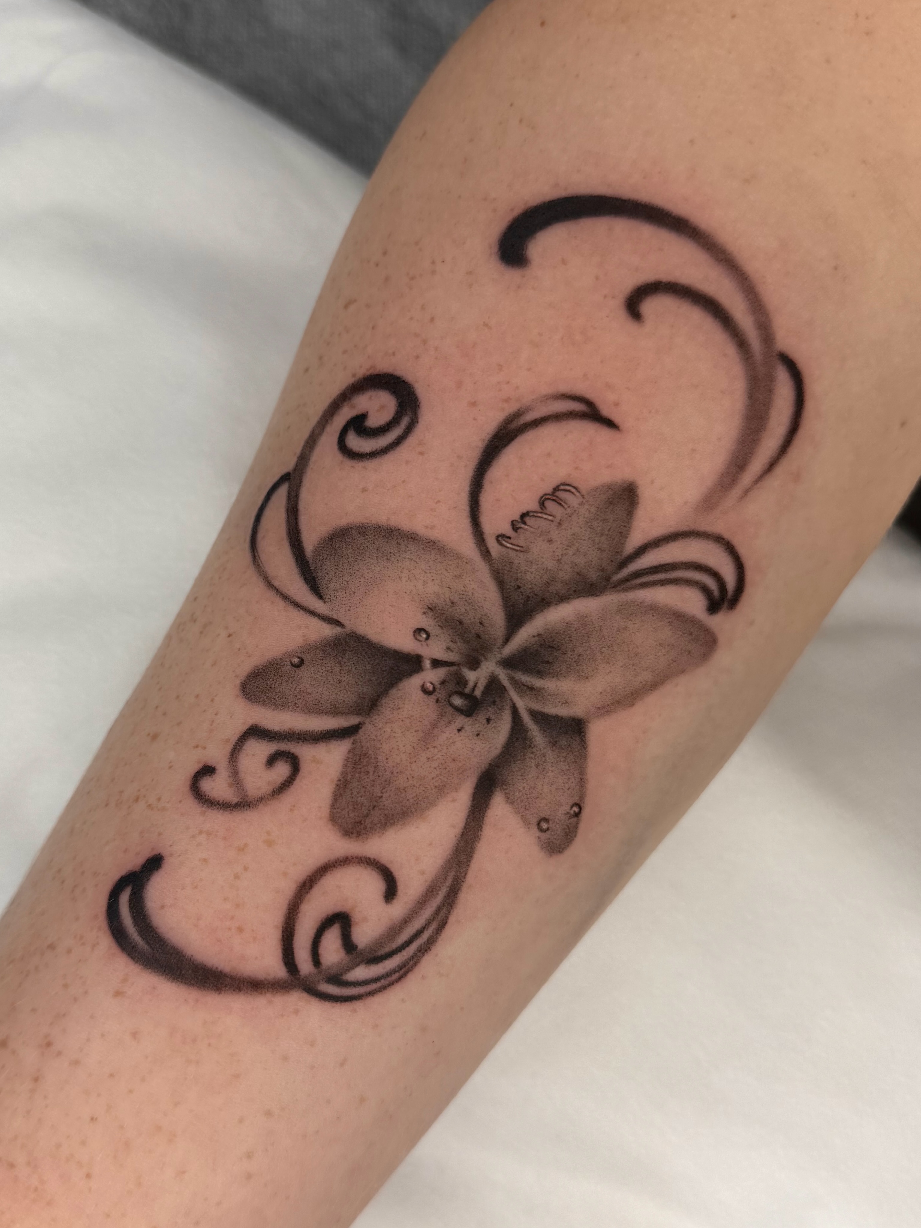 Flower black and grey tattoo on the forearm by Red