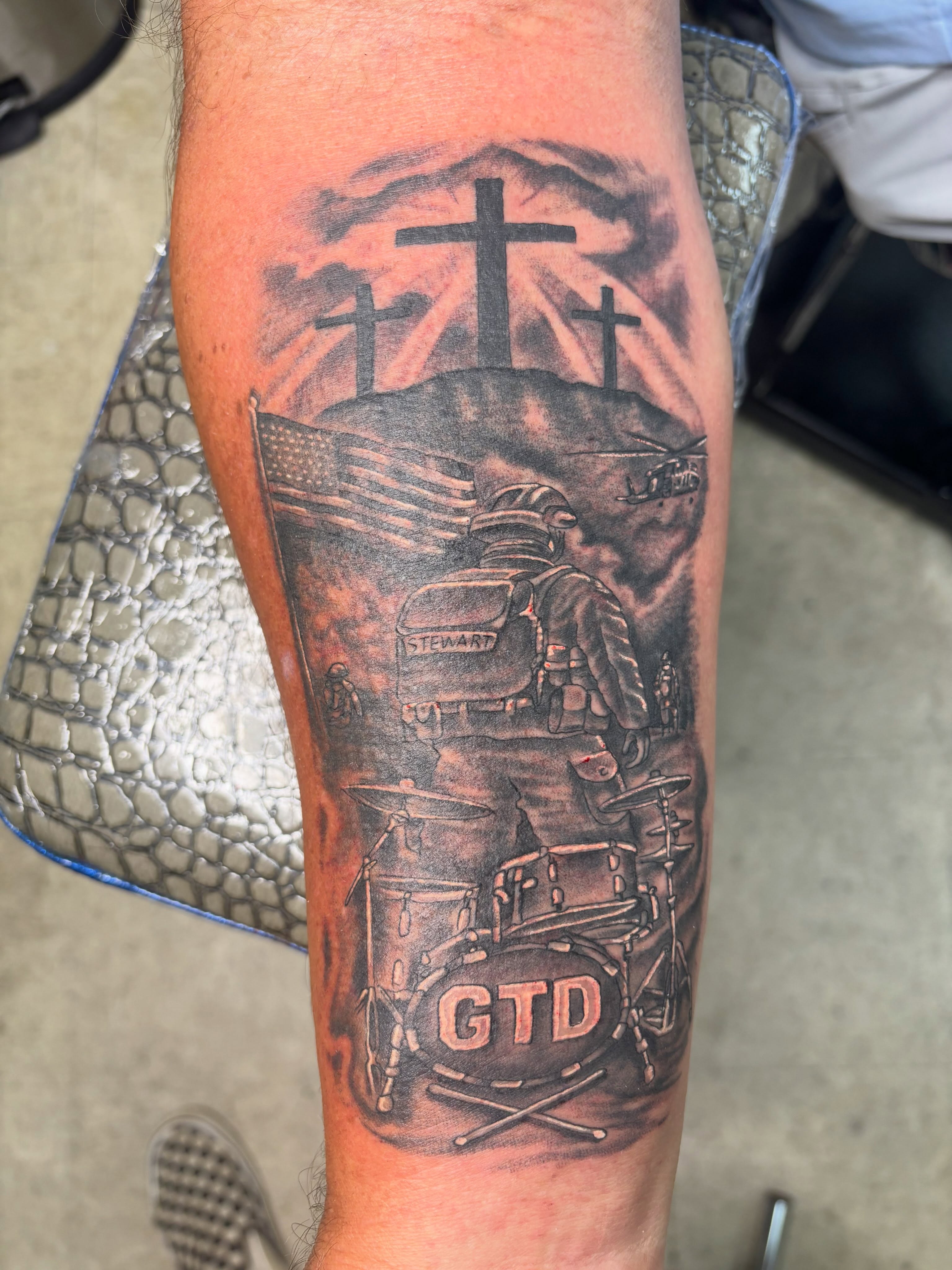 Drummer with crosses realism tattoo on the forearm by Shane Montie, Killeen, Texas