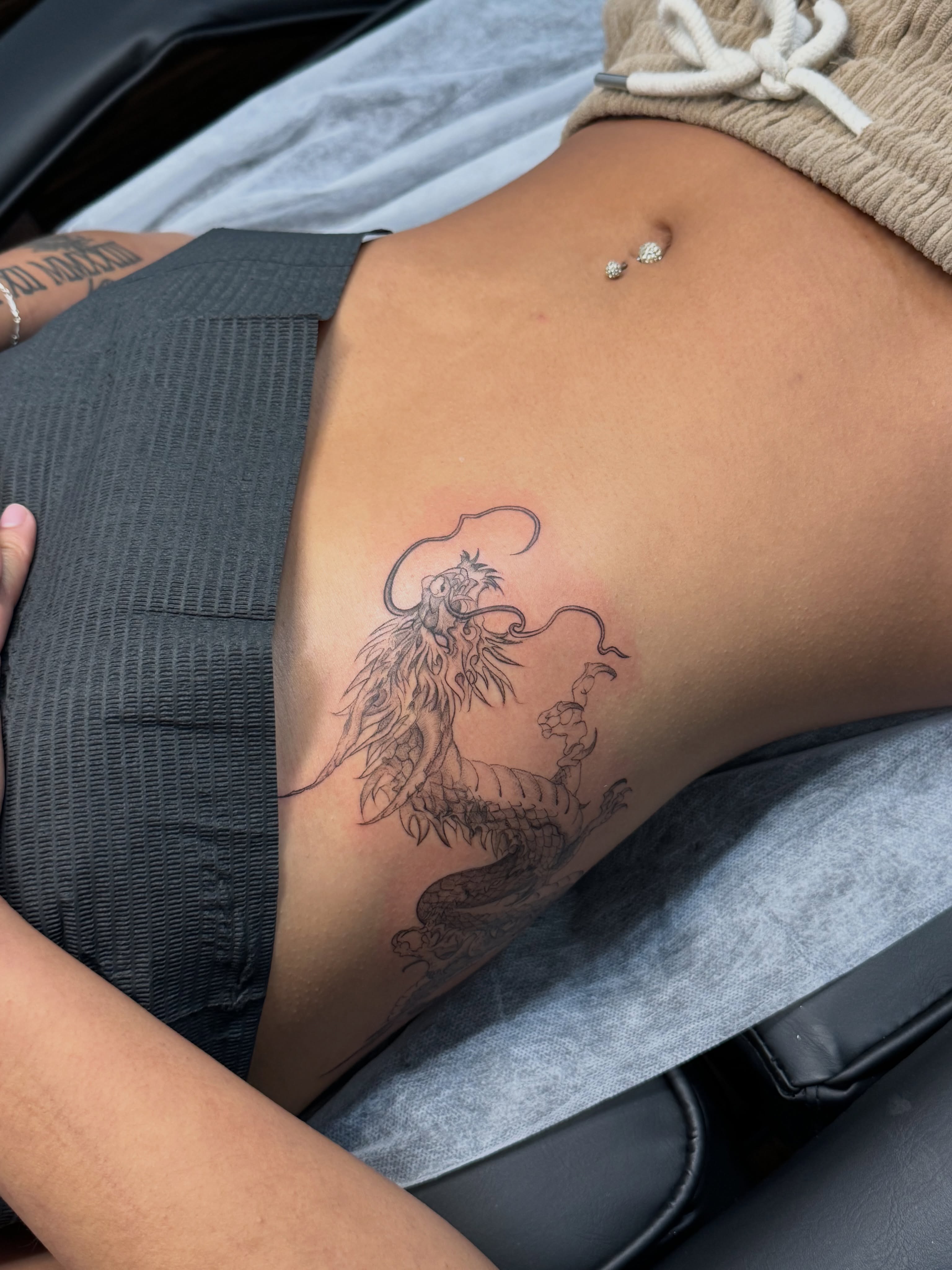 Phoenix black and grey tattoo on the ribs by Ava De La Torre