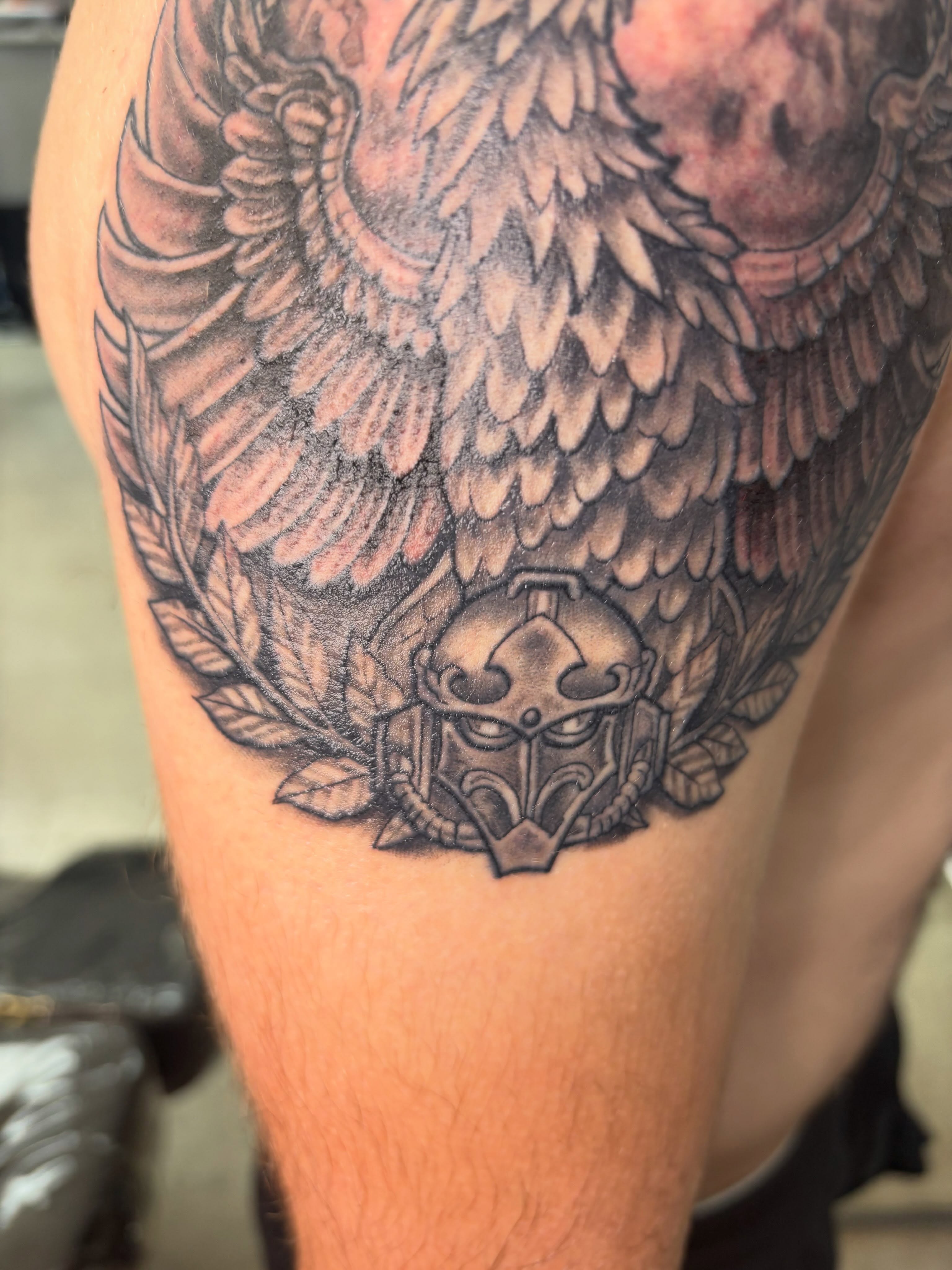 Winged helmet black and grey tattoo on the thigh by Shane Montie, Killeen, Texas
