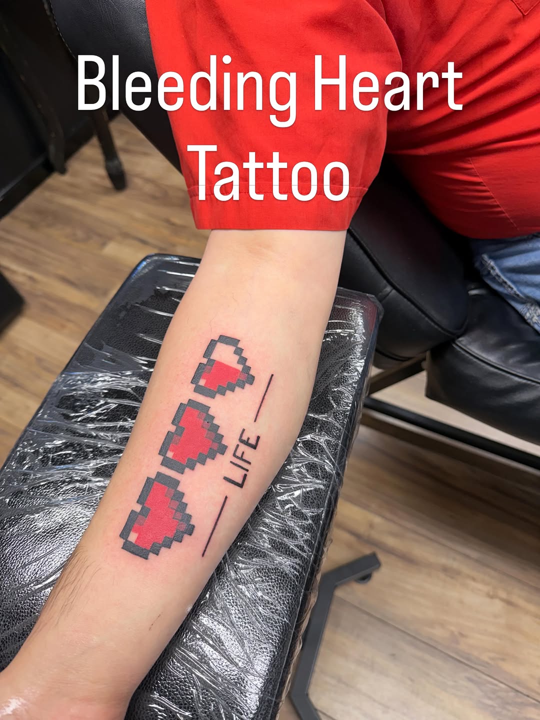 Pixelated hearts and text tattoo on the forearm by Justin Evans kc ink
