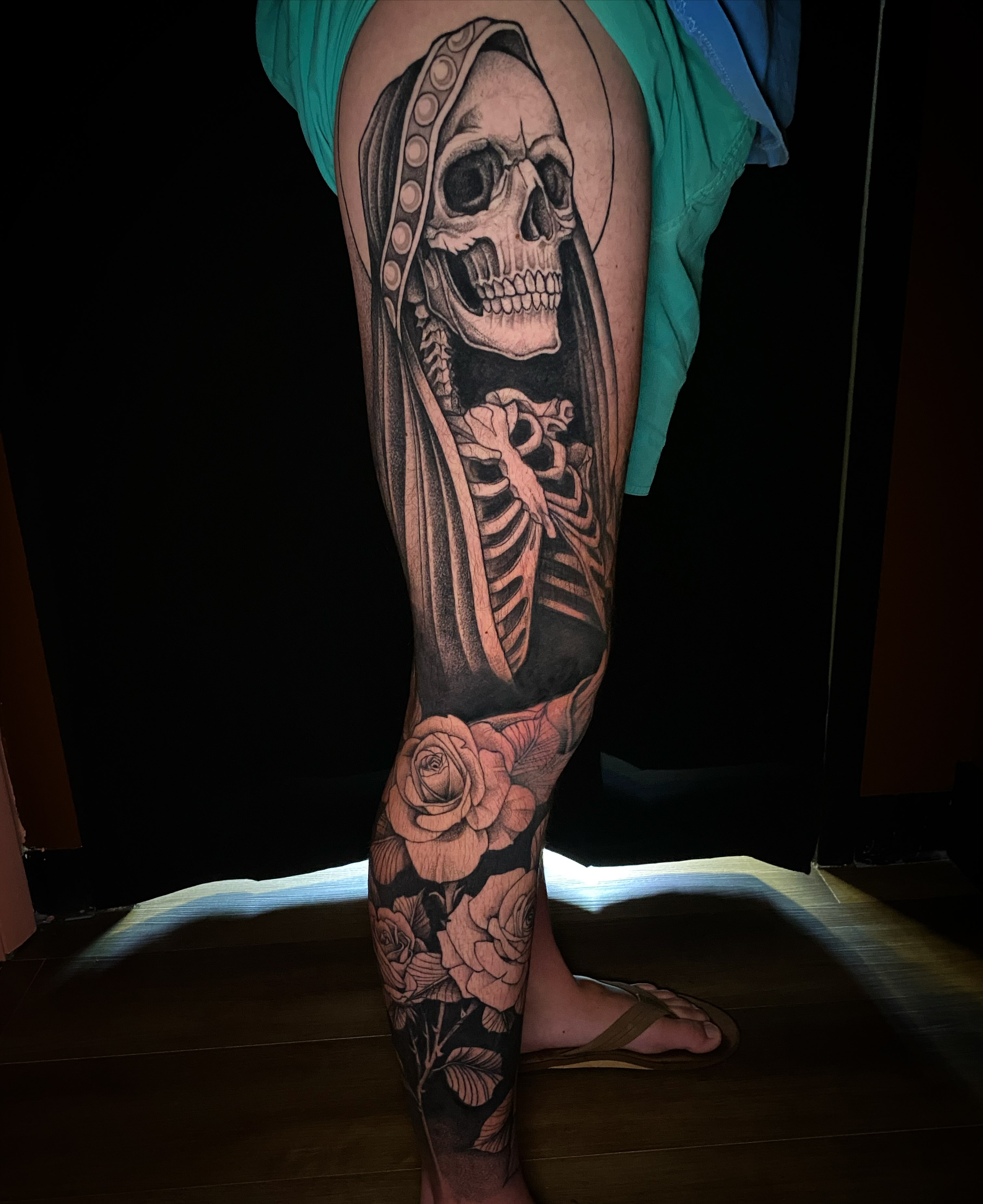 Skeleton with roses realism tattoo on the leg by Casey Dohner