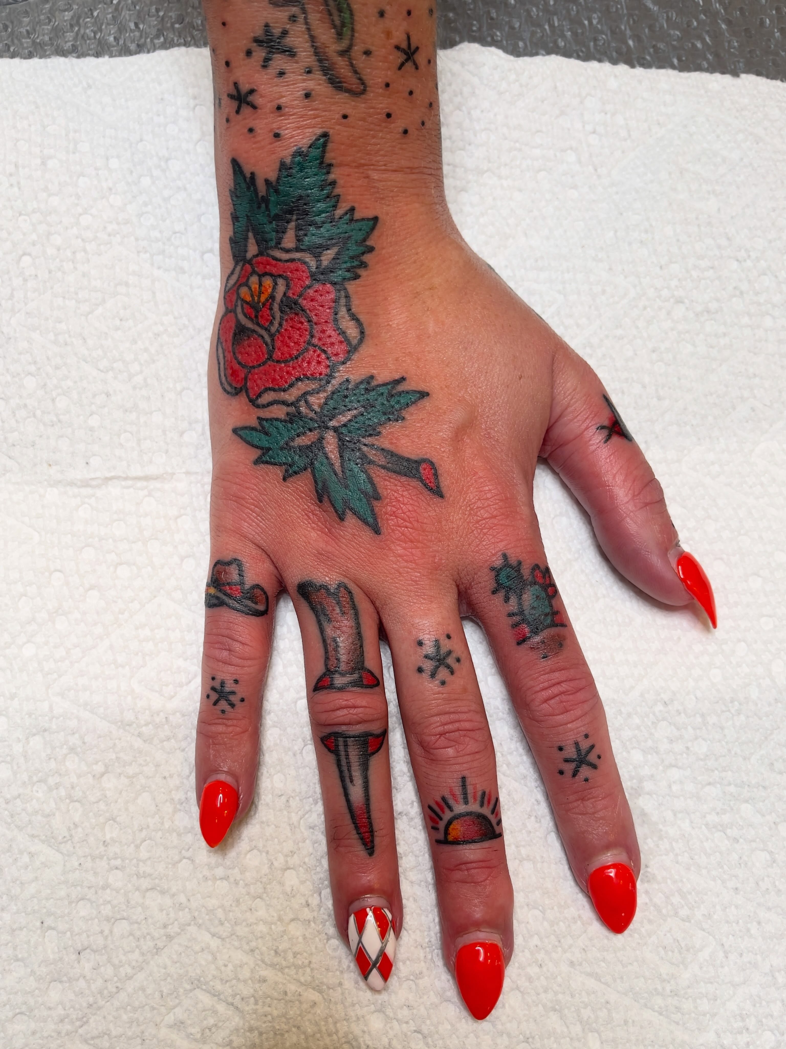 Rose and dagger American traditional tattoo on the hand by Spencer Reisbeck