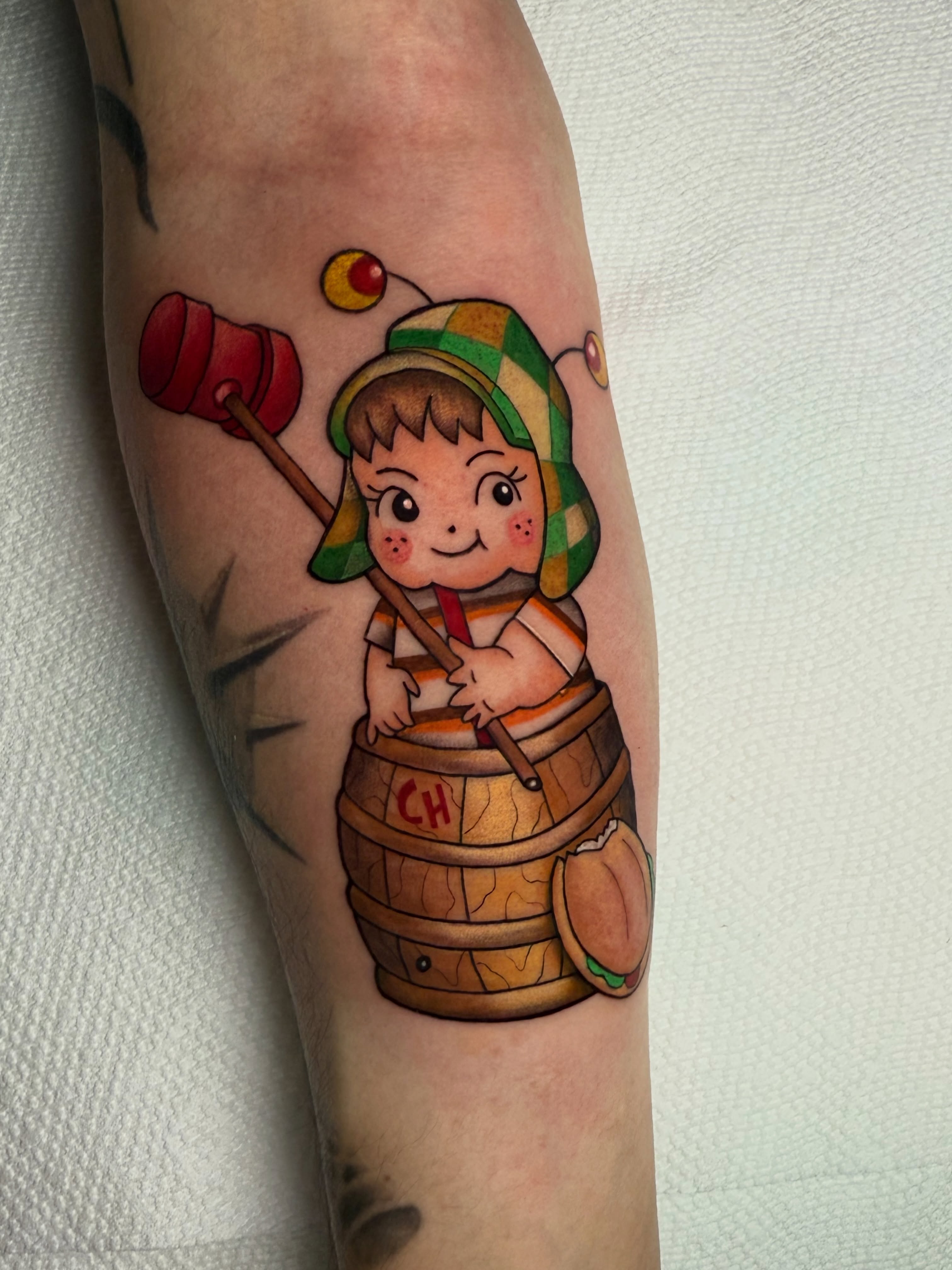 Child in barrel illustrative tattoo on the forearm by Alexia