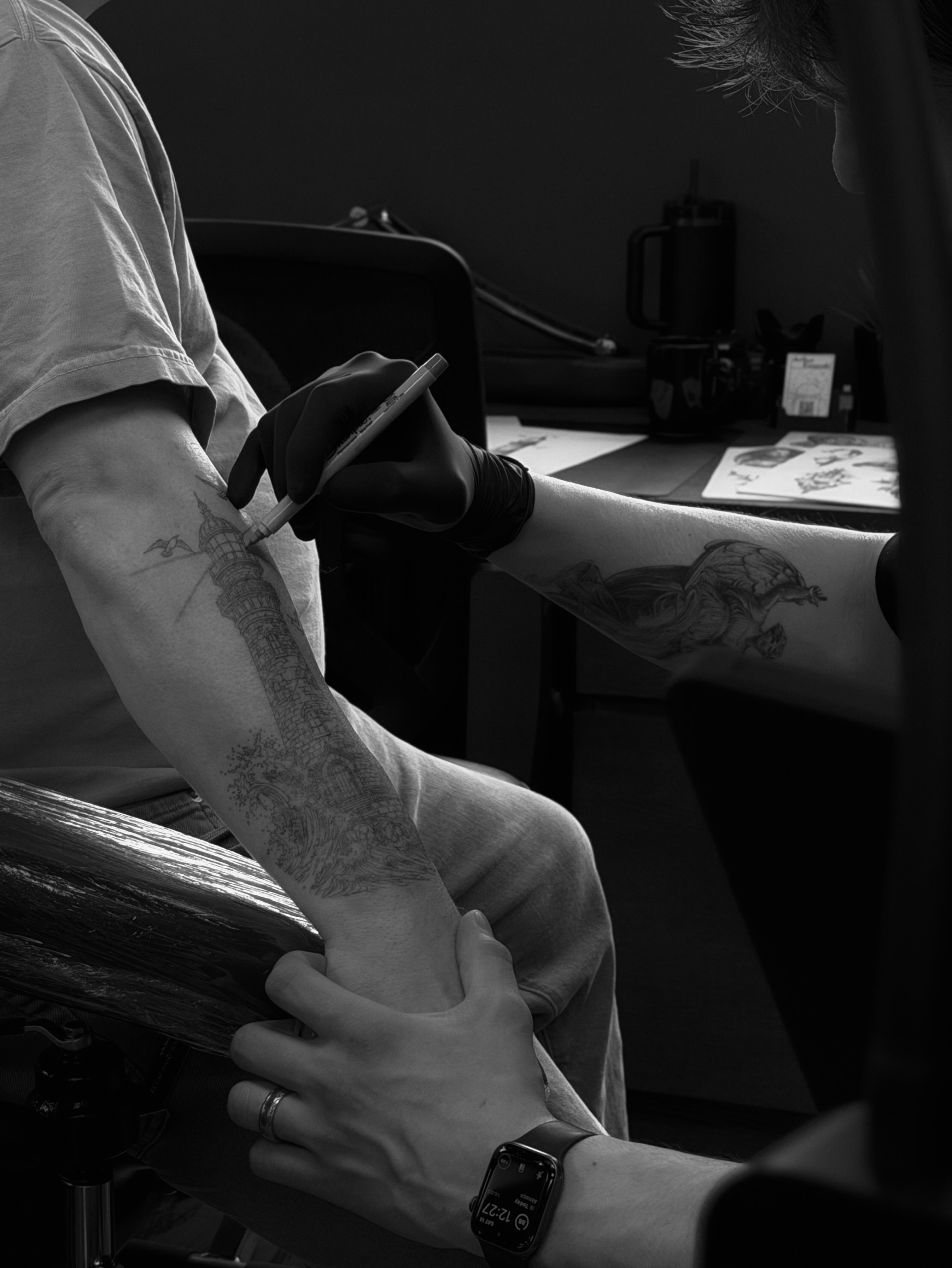 Lighthouse black and grey tattoo on the forearm by Arthur Kossoski