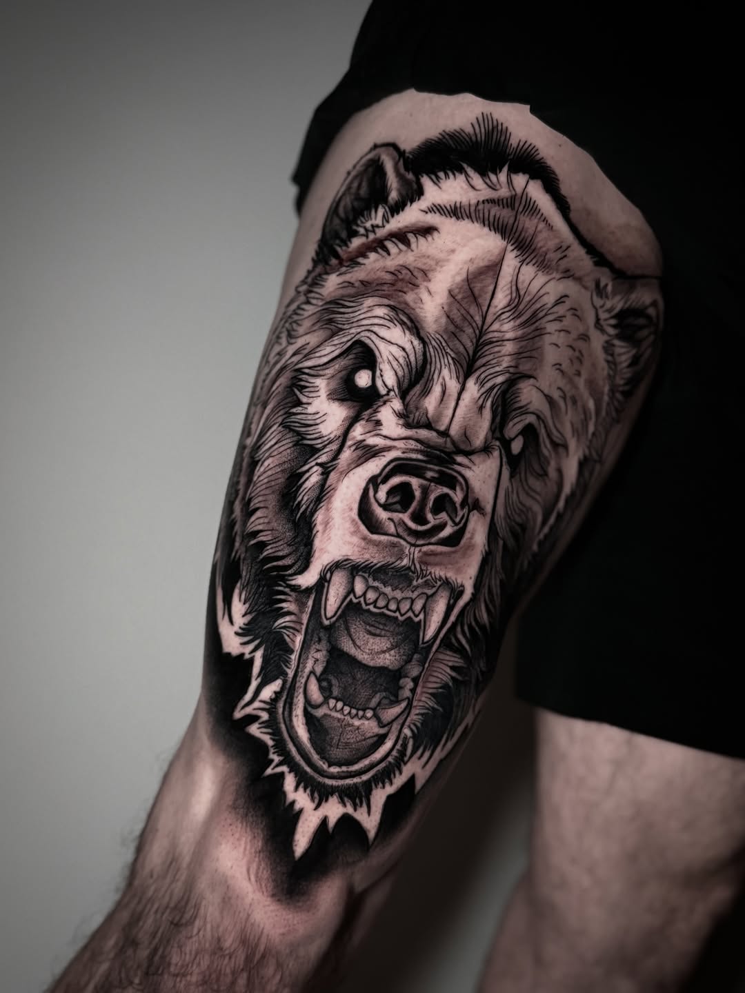 Bear head realism tattoo on the thigh by David Mushaney
