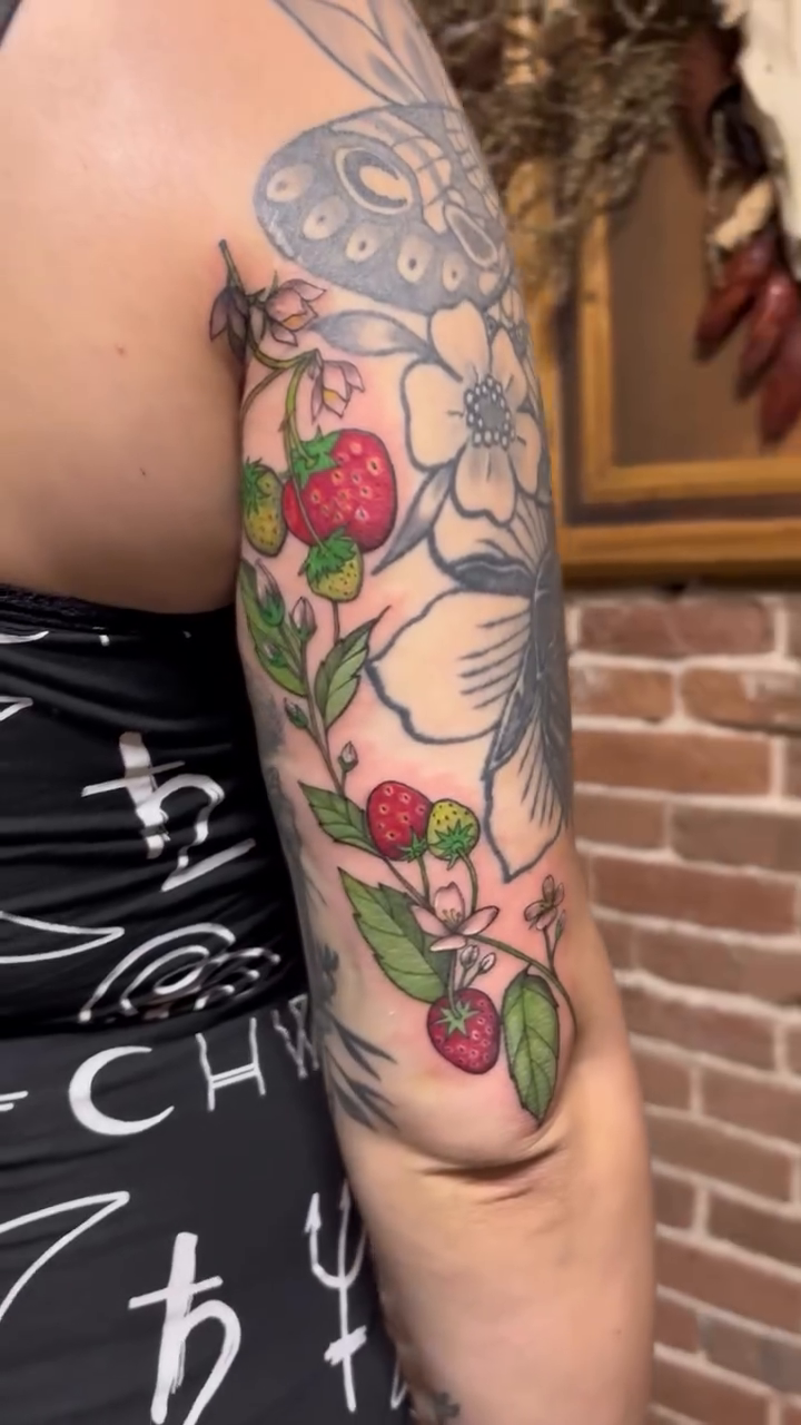Strawberries and flowers on arm neo-traditional tattoo on the upper arm by Tattoo Artist, Kansas City, Missouri
