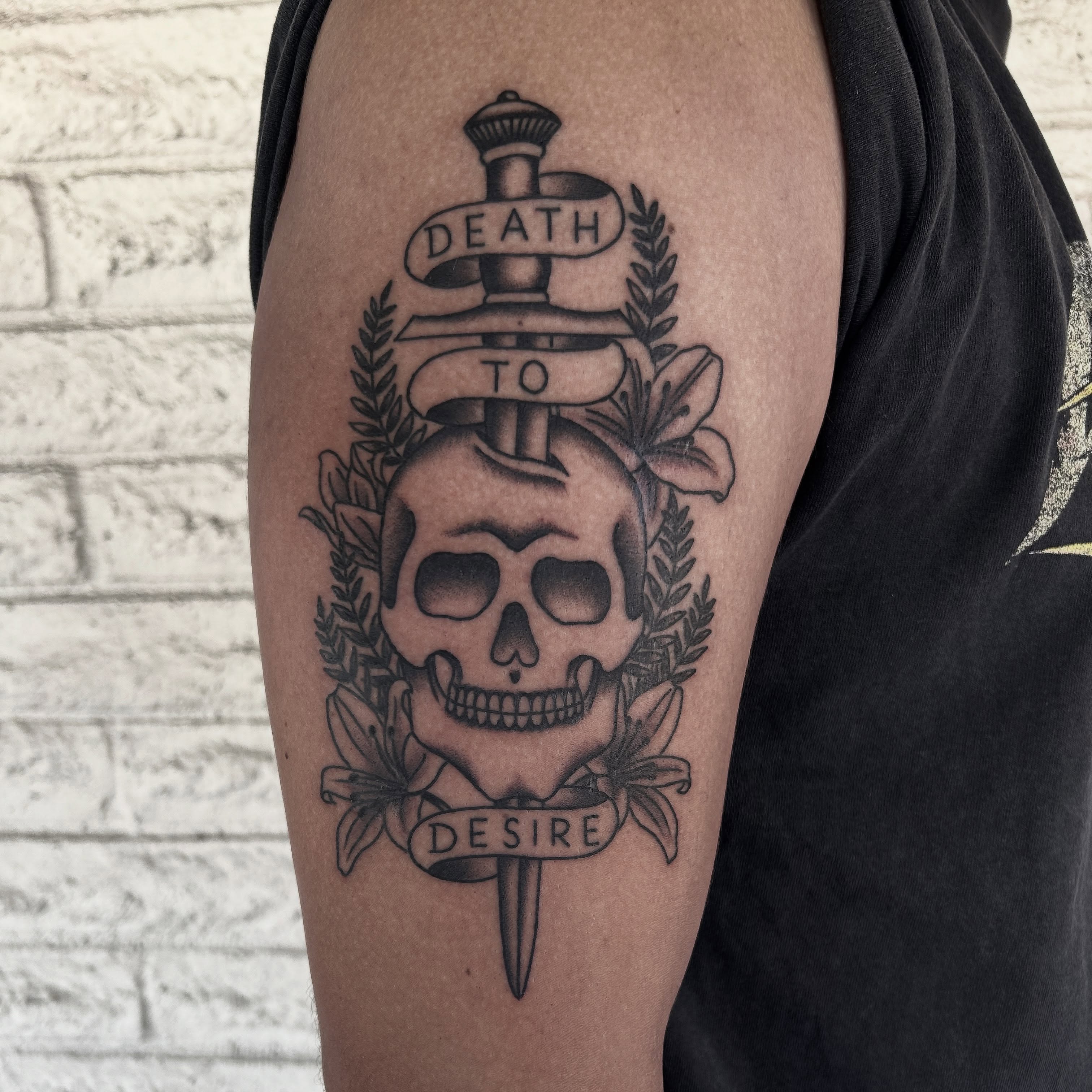 Skull with dagger black and grey tattoo on the forearm by Stephen Sanchez