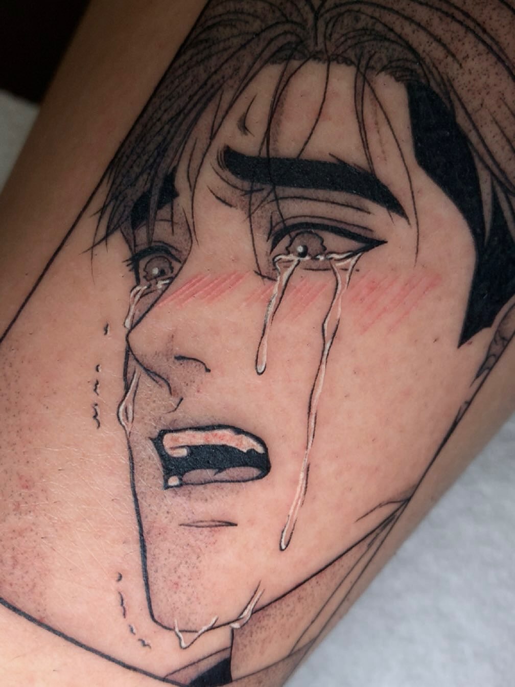 Crying face realism tattoo on the thigh by Maddie Rees