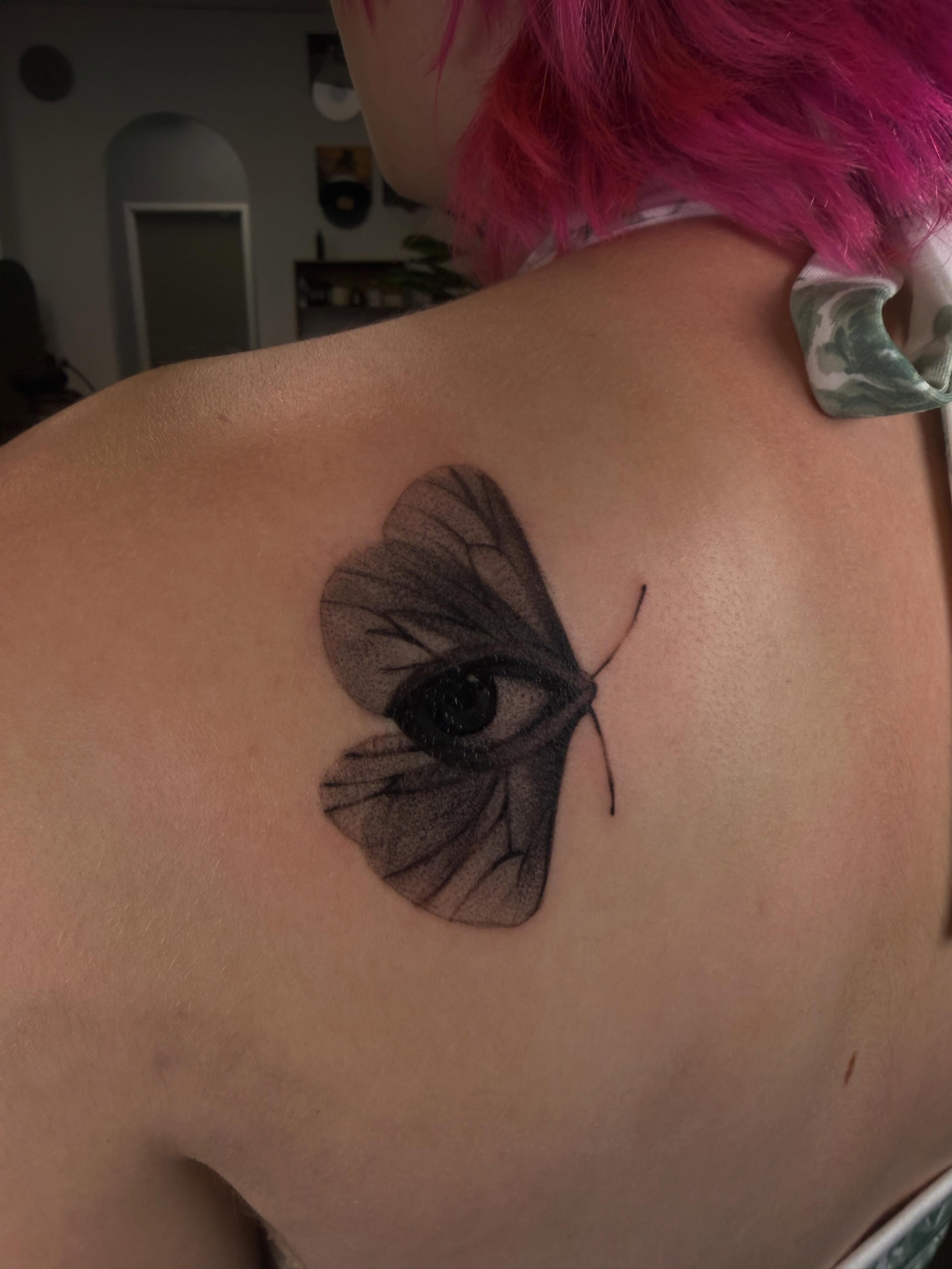 Eye with butterfly wings dotwork tattoo on the shoulder by Lxx.