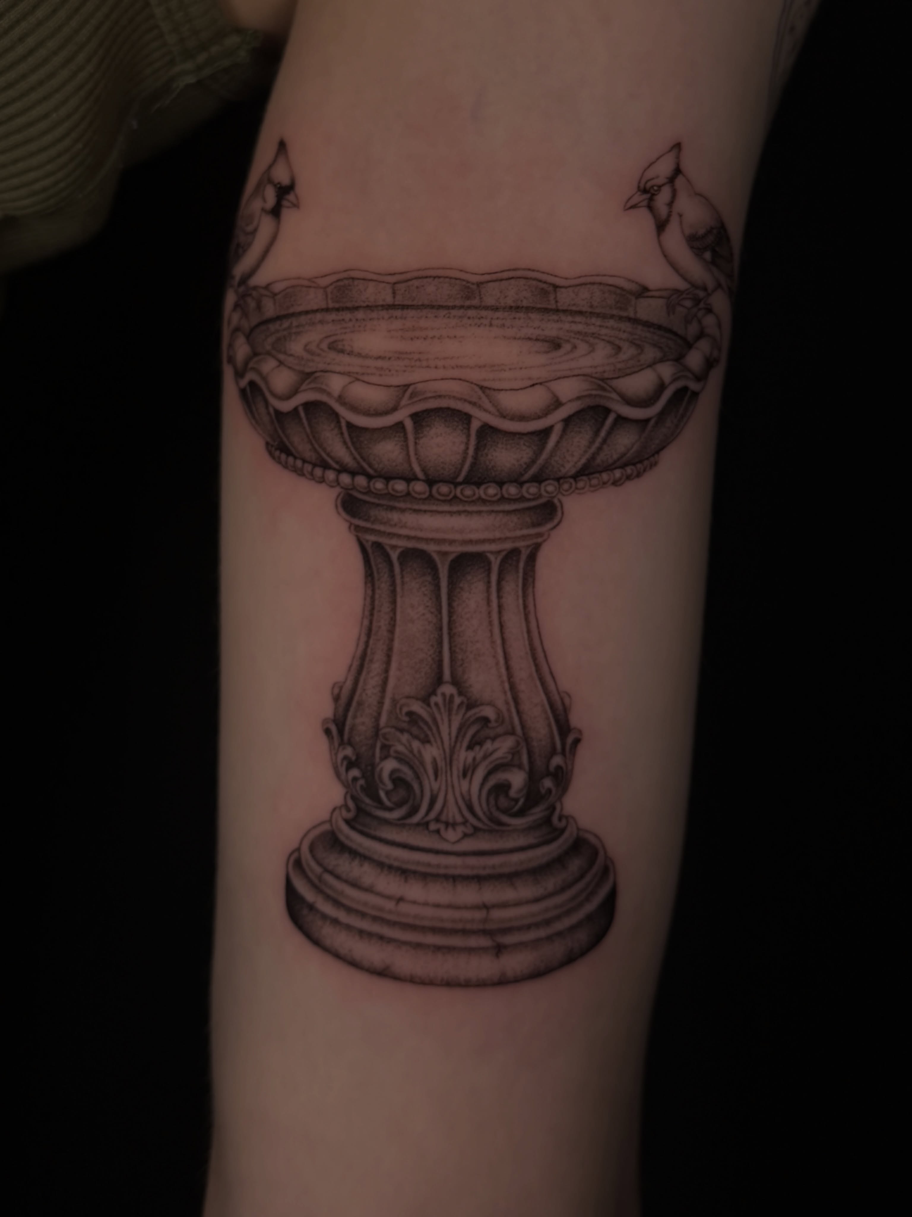 Bird bath realism tattoo on the forearm by Marianne