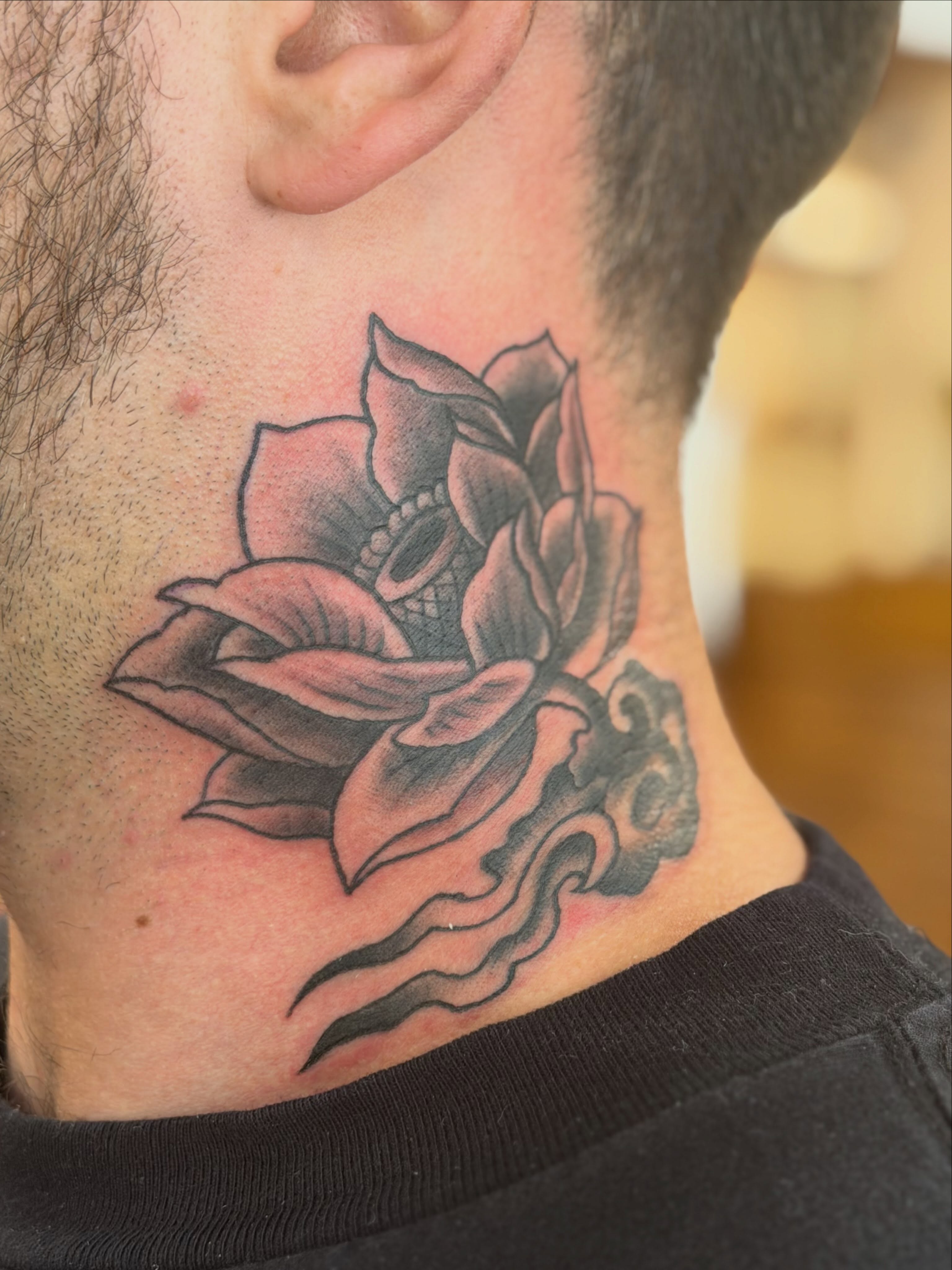 Lotus flower black and grey tattoo on the neck by Colbylee Tattoo Norwich