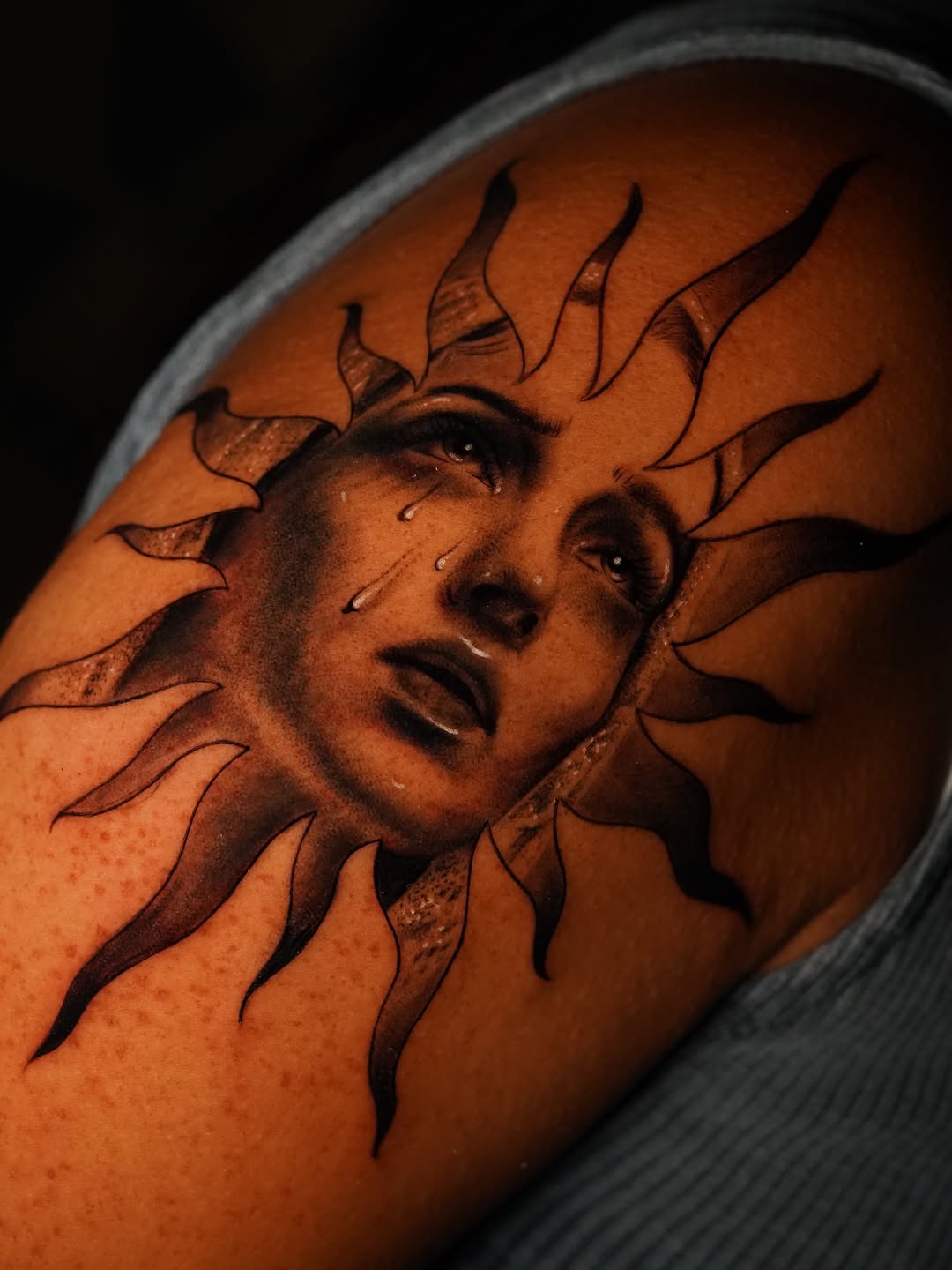 Crying sun face realism tattoo on the shoulder by Jennifer Garcia