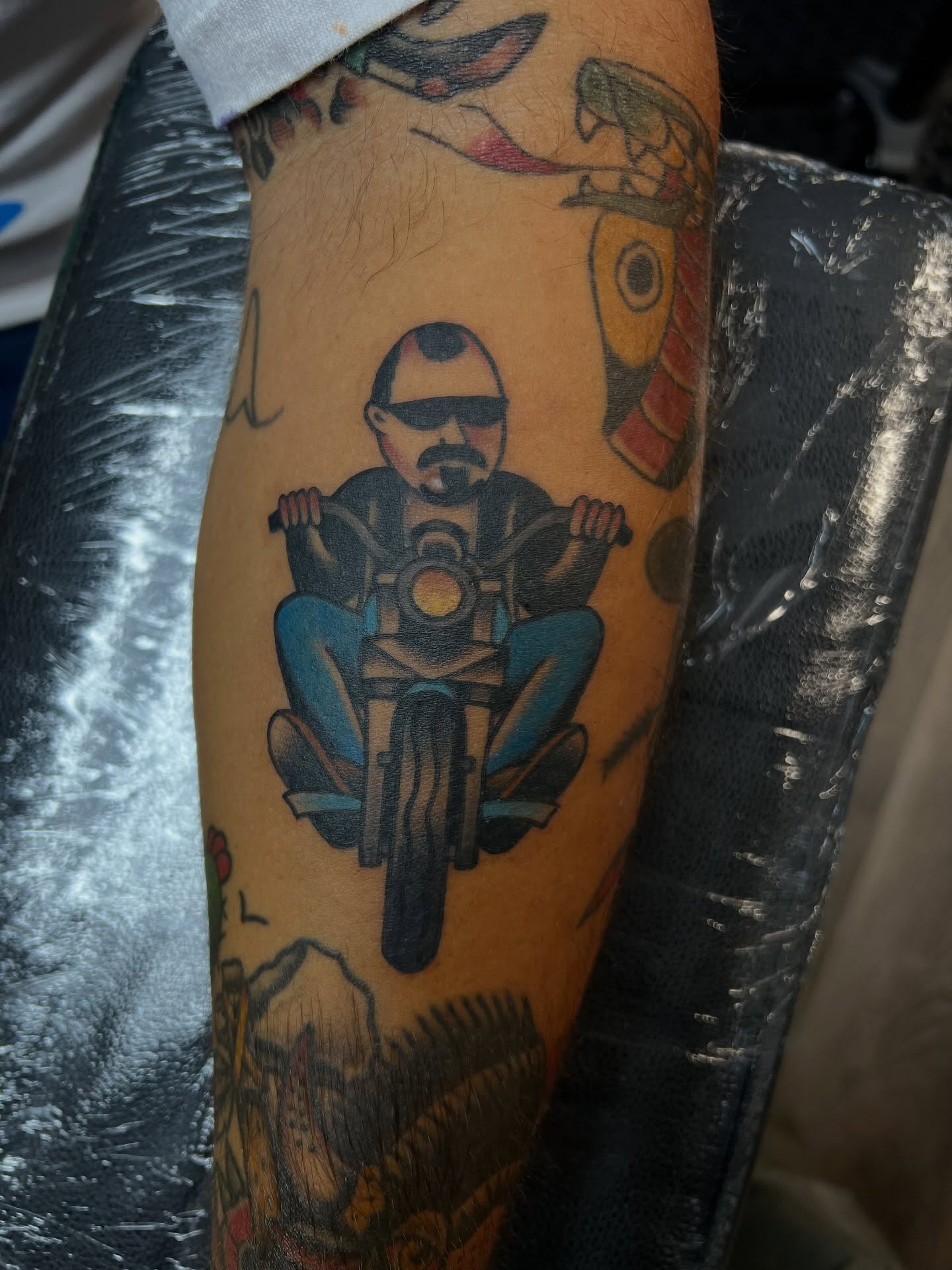 Motorcycle rider American traditional tattoo on the forearm by Tyler Van Pelt