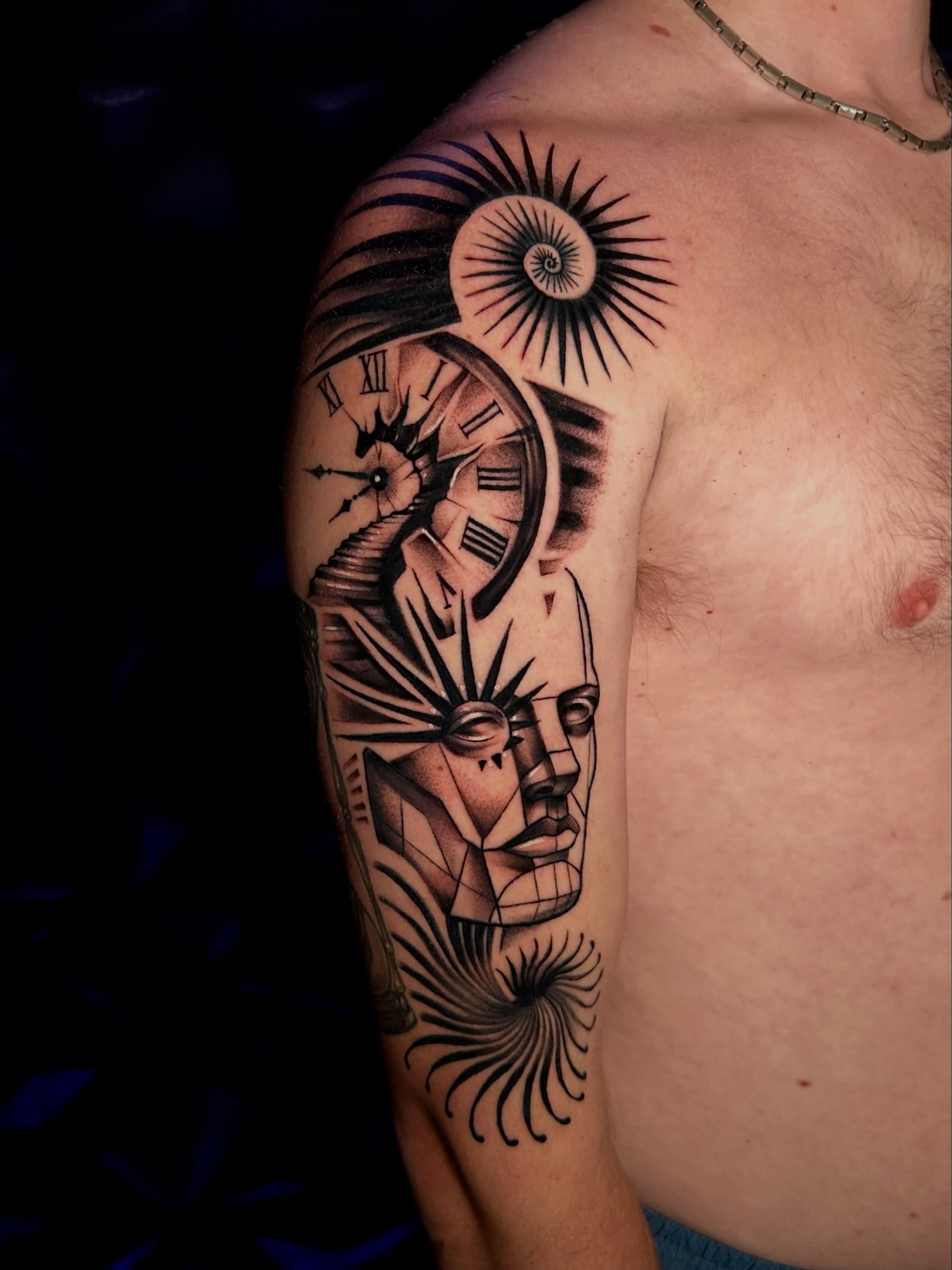 Abstract face with clock geometric tattoo on the shoulder by Haleigh Cunningham, Charlotte, North Carolina
