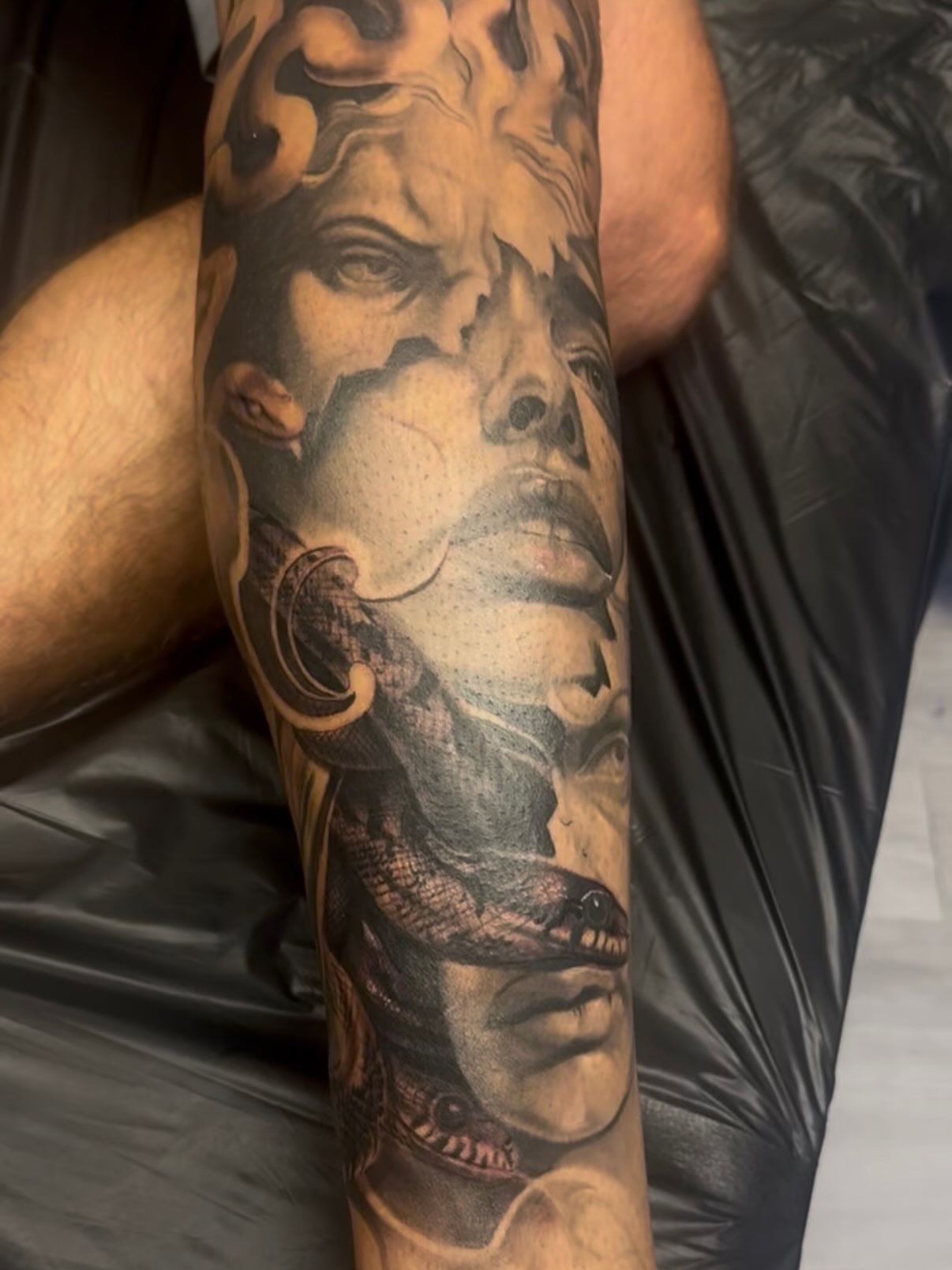 Portrait with snake realism tattoo on the forearm by Eric RudeInk