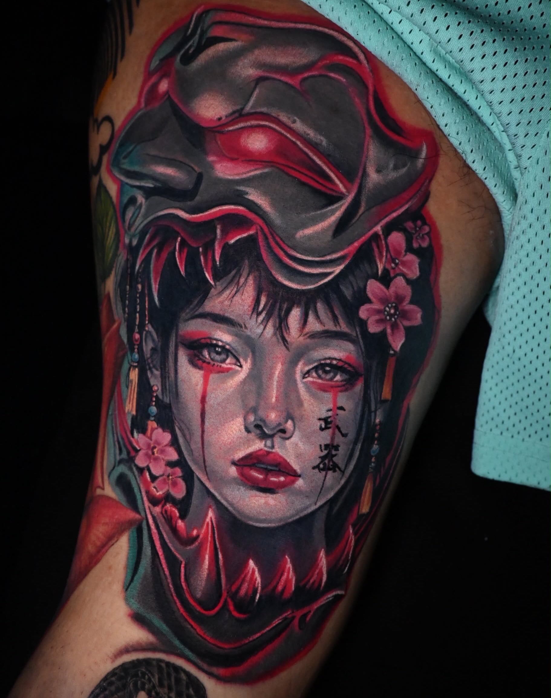 Geisha with mask neo-traditional tattoo on the upper arm by William Pollock