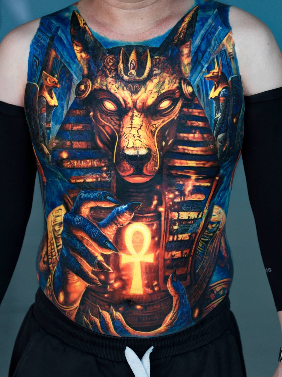 Anubis holding an ankh surrealism tattoo on the chest by Bình Nguyễn