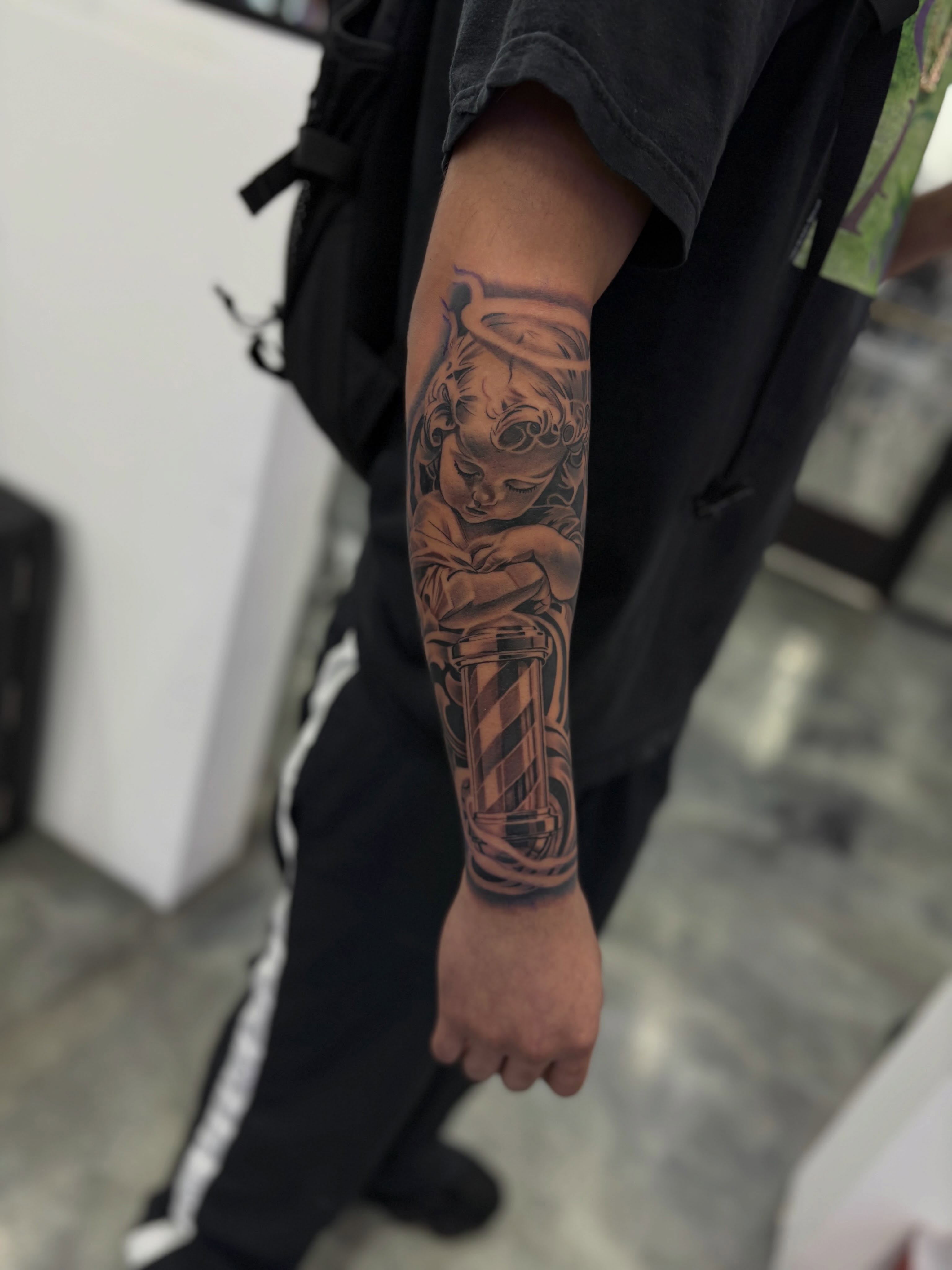 Child with striped pole black and grey tattoo on the forearm by Devin