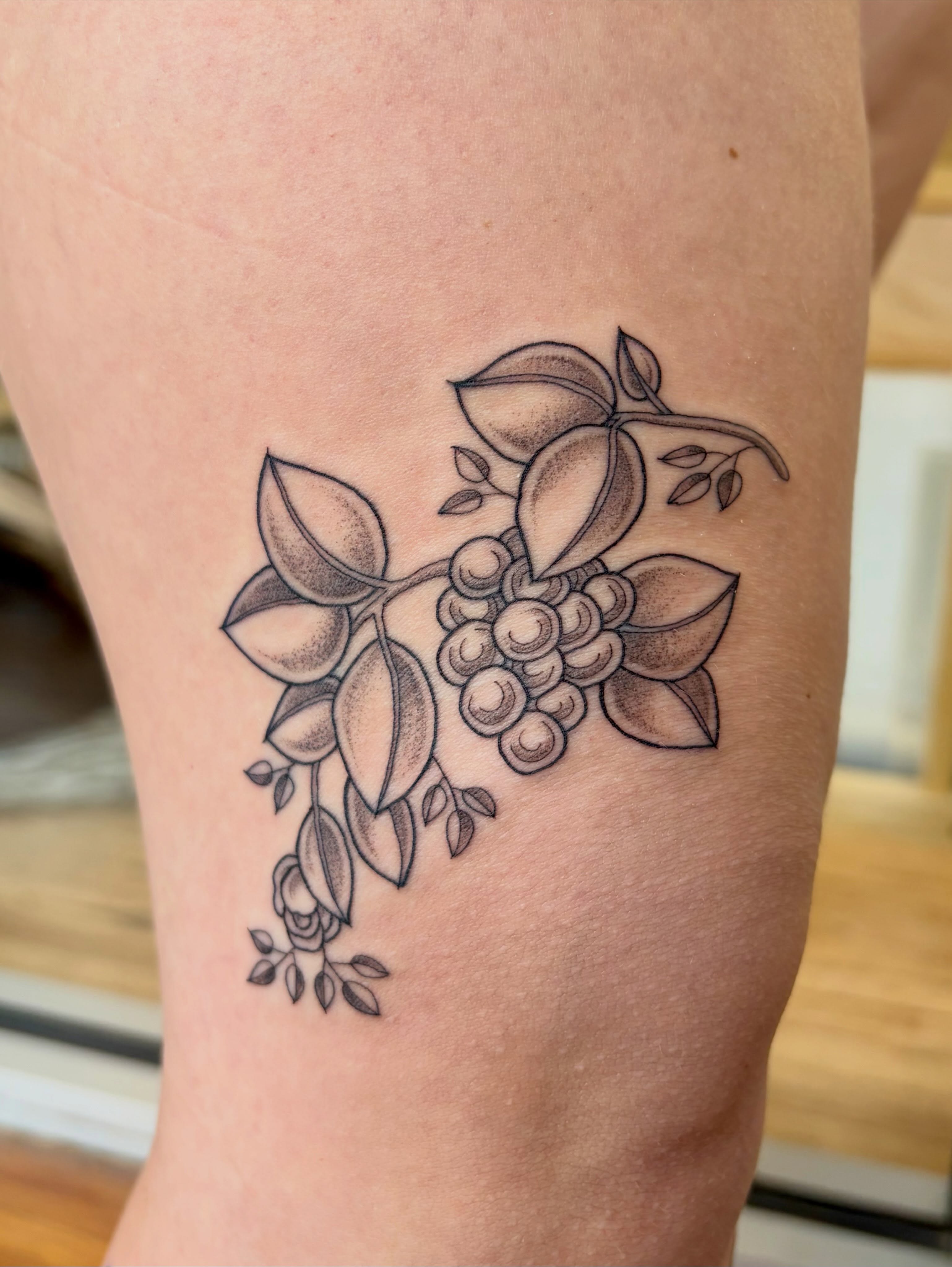 Berry cluster dotwork tattoo on the thigh by Sarah Roach