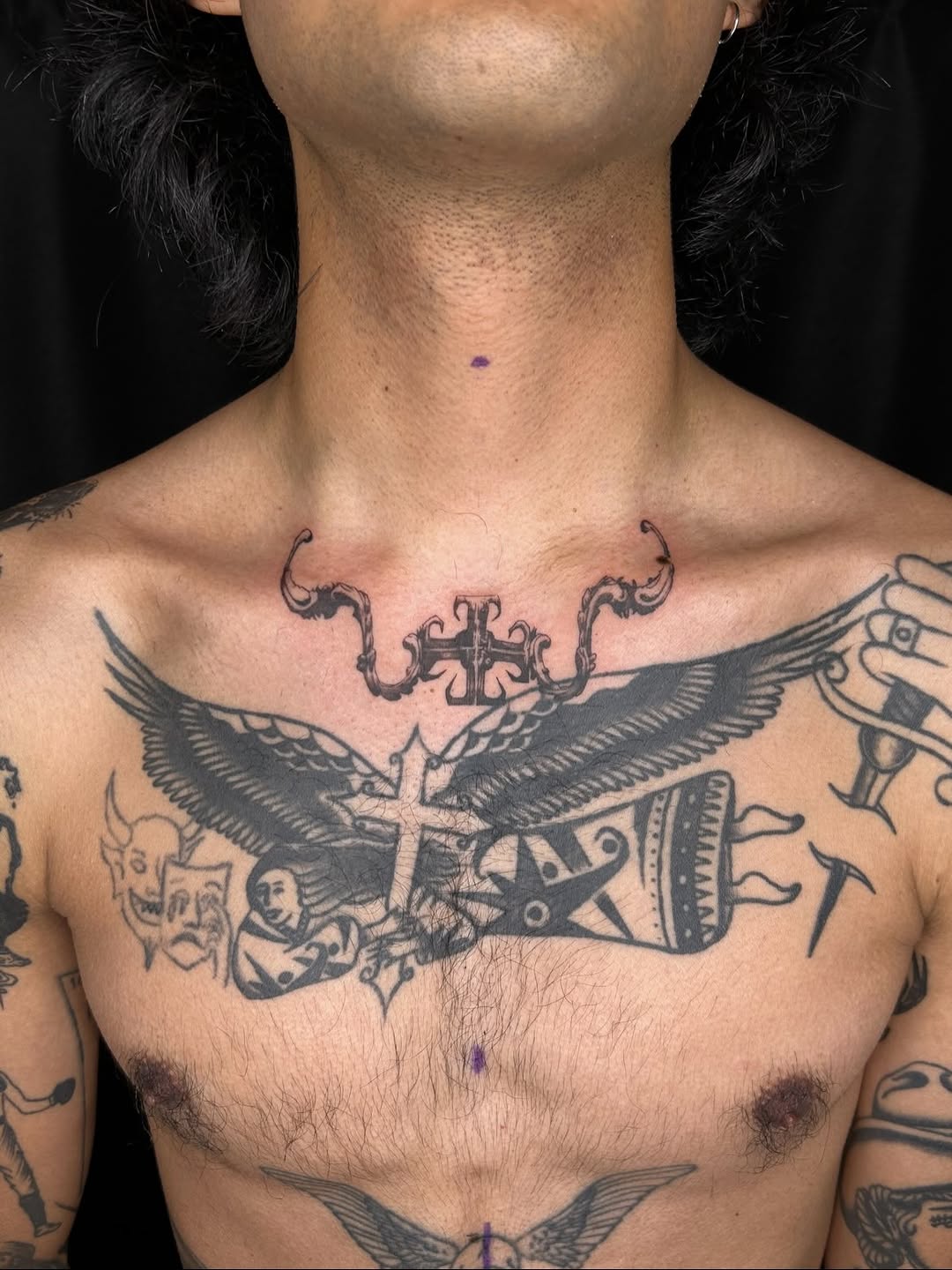 Eagle with cross and ornamental elements blackwork tattoo on the chest by Jadin Nichols