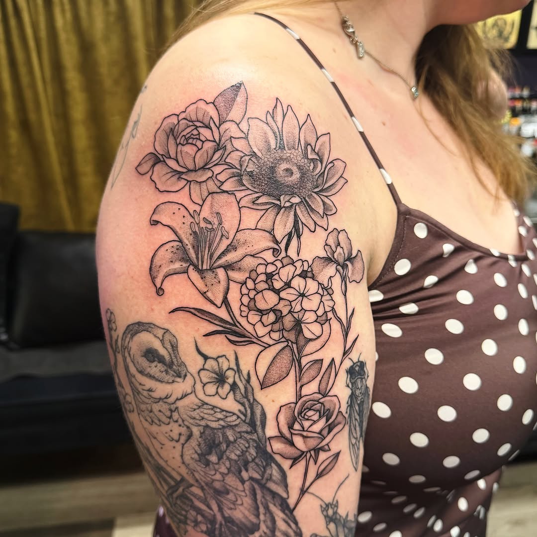Floral bouquet black and grey tattoo on the shoulder by Emily