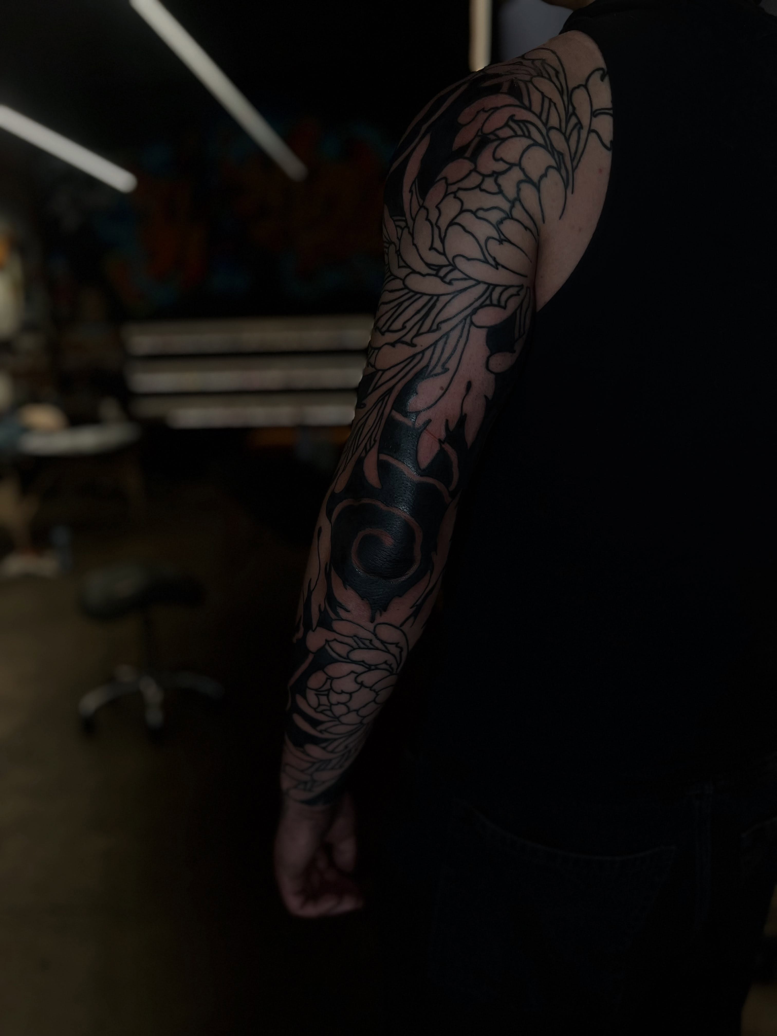 Floral design black and grey tattoo on the upper arm by Kaichi Fujita, Eugene, Oregon