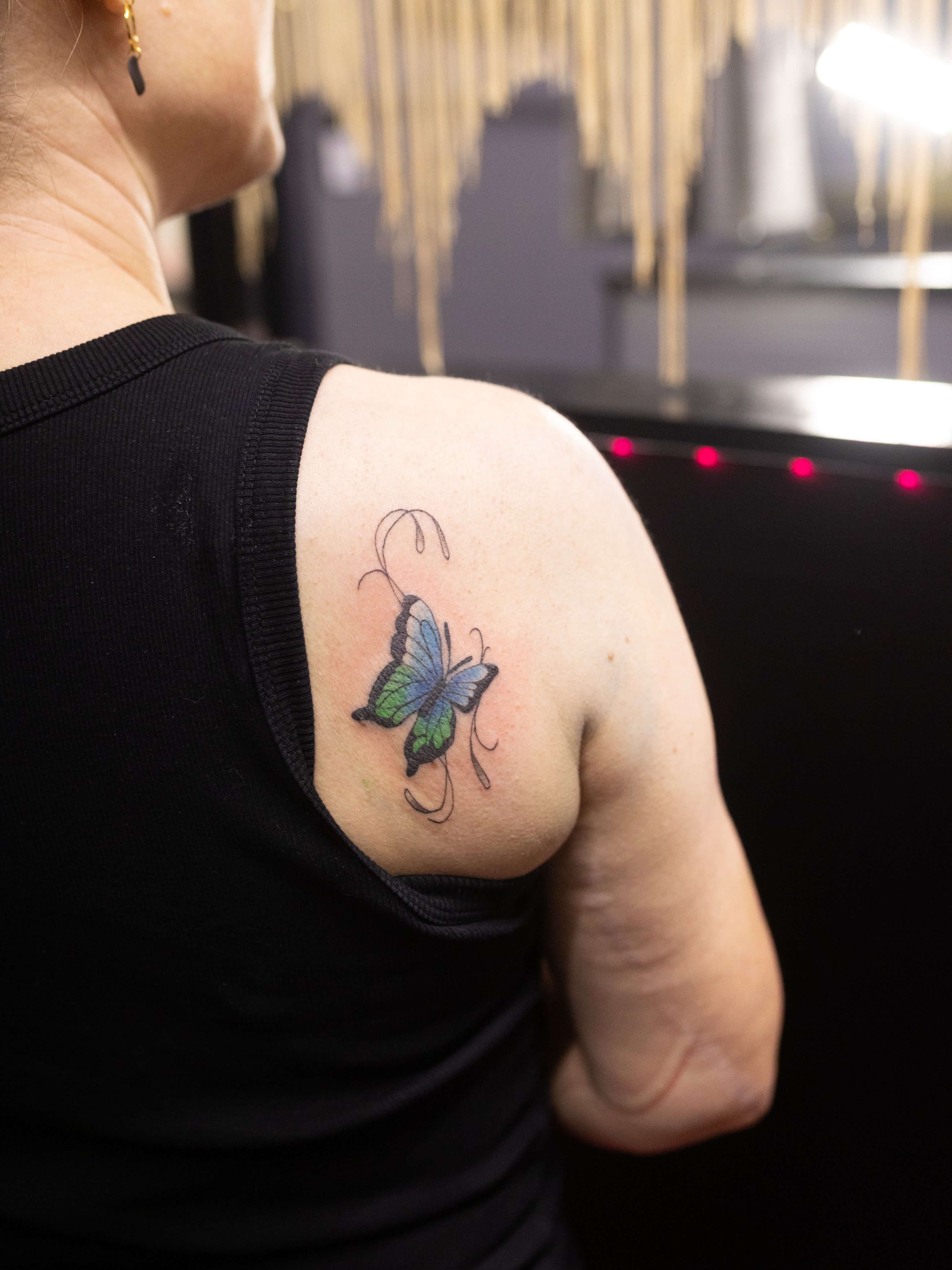 Butterfly realism tattoo on the shoulder by Kelsie