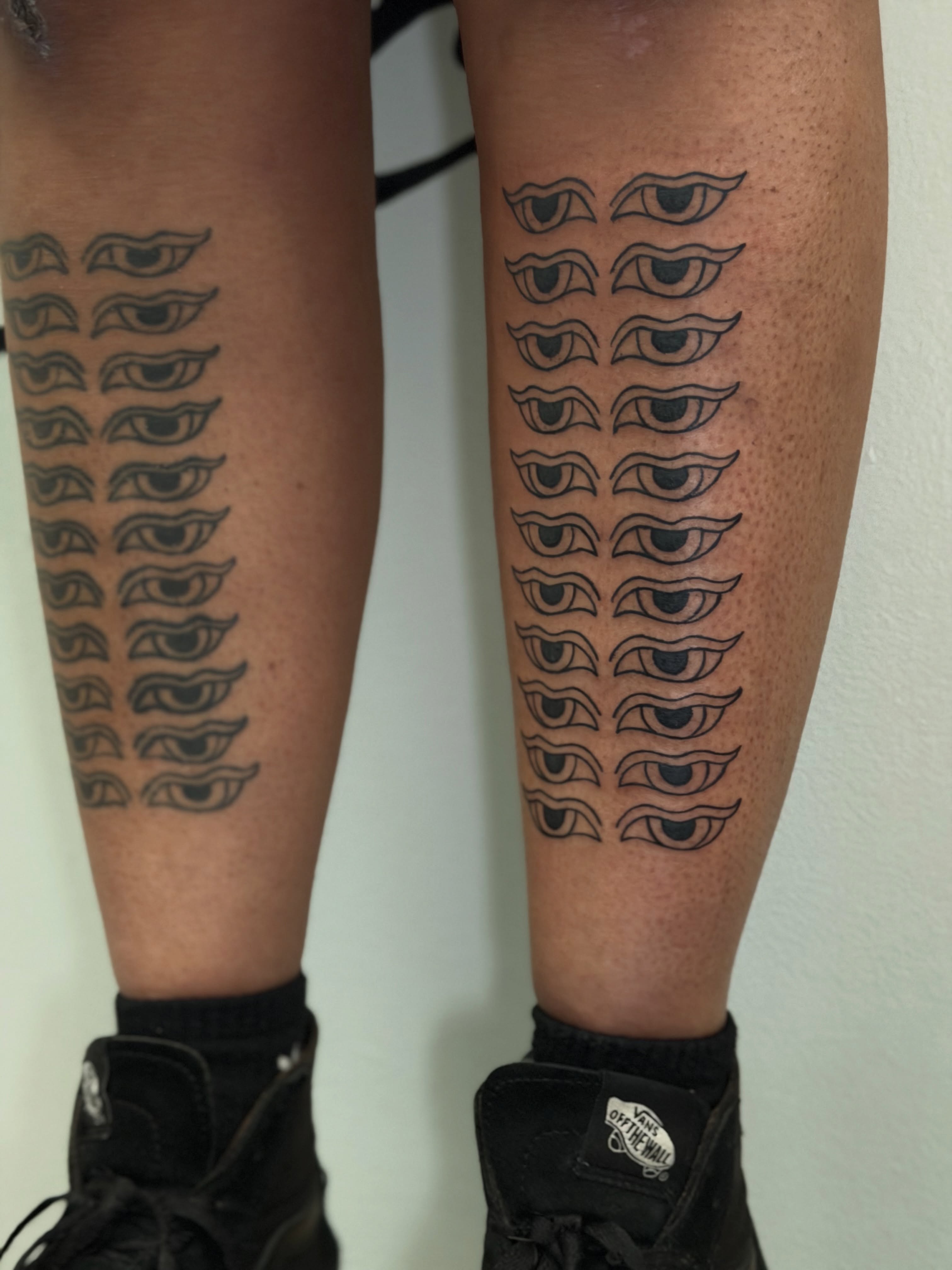 Eyes black and grey tattoo on the calf by Joey Taylor
