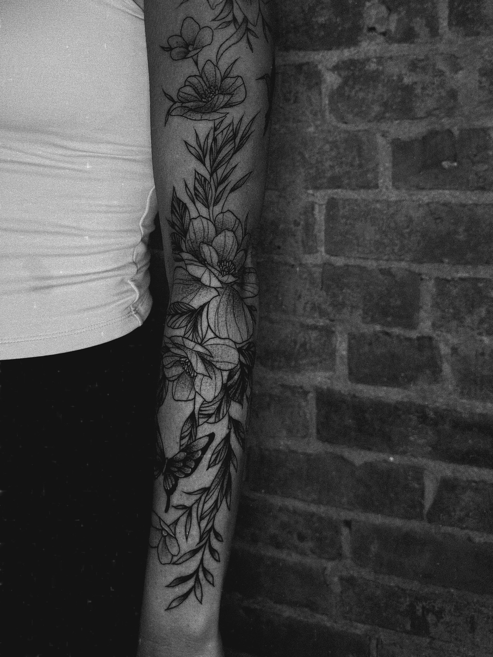 Floral arrangement black and grey tattoo on the forearm by E L I Z A H B e T H H D e S I G N S