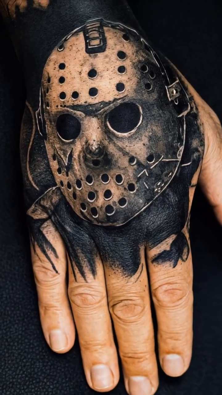 Jason Voorhees mask on hand realism tattoo on the hand by Mak$ Brand