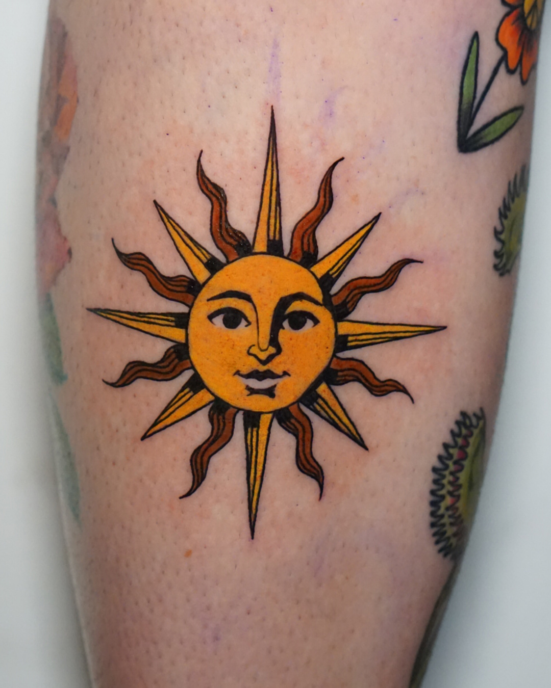 Sun American traditional tattoo on the forearm by San Diego Color Realism and Neotraditional