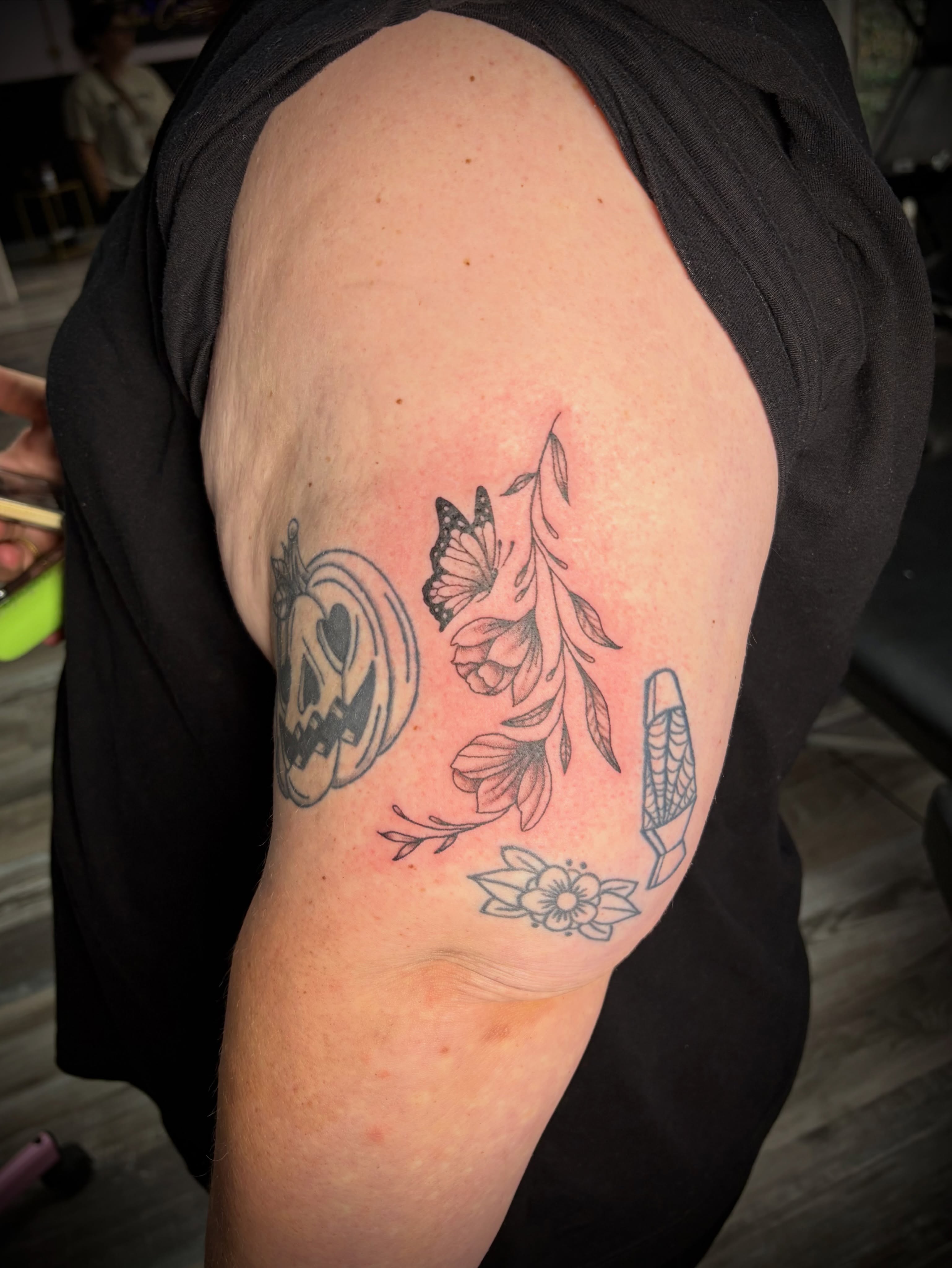 Floral arrangement black and grey tattoo on the shoulder by Kiersten Tickle