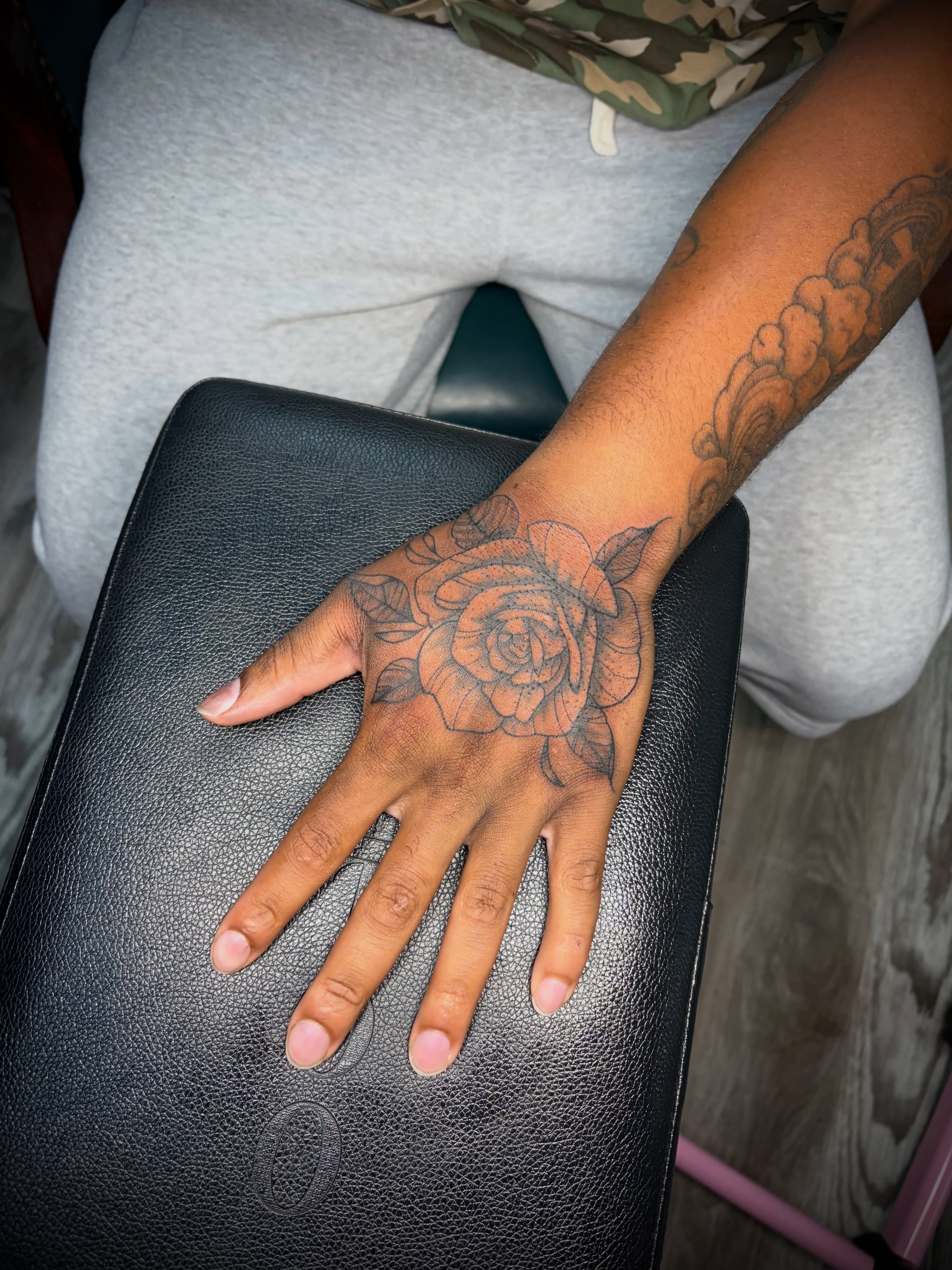 Rose black and grey tattoo on the hand by Kiersten Tickle