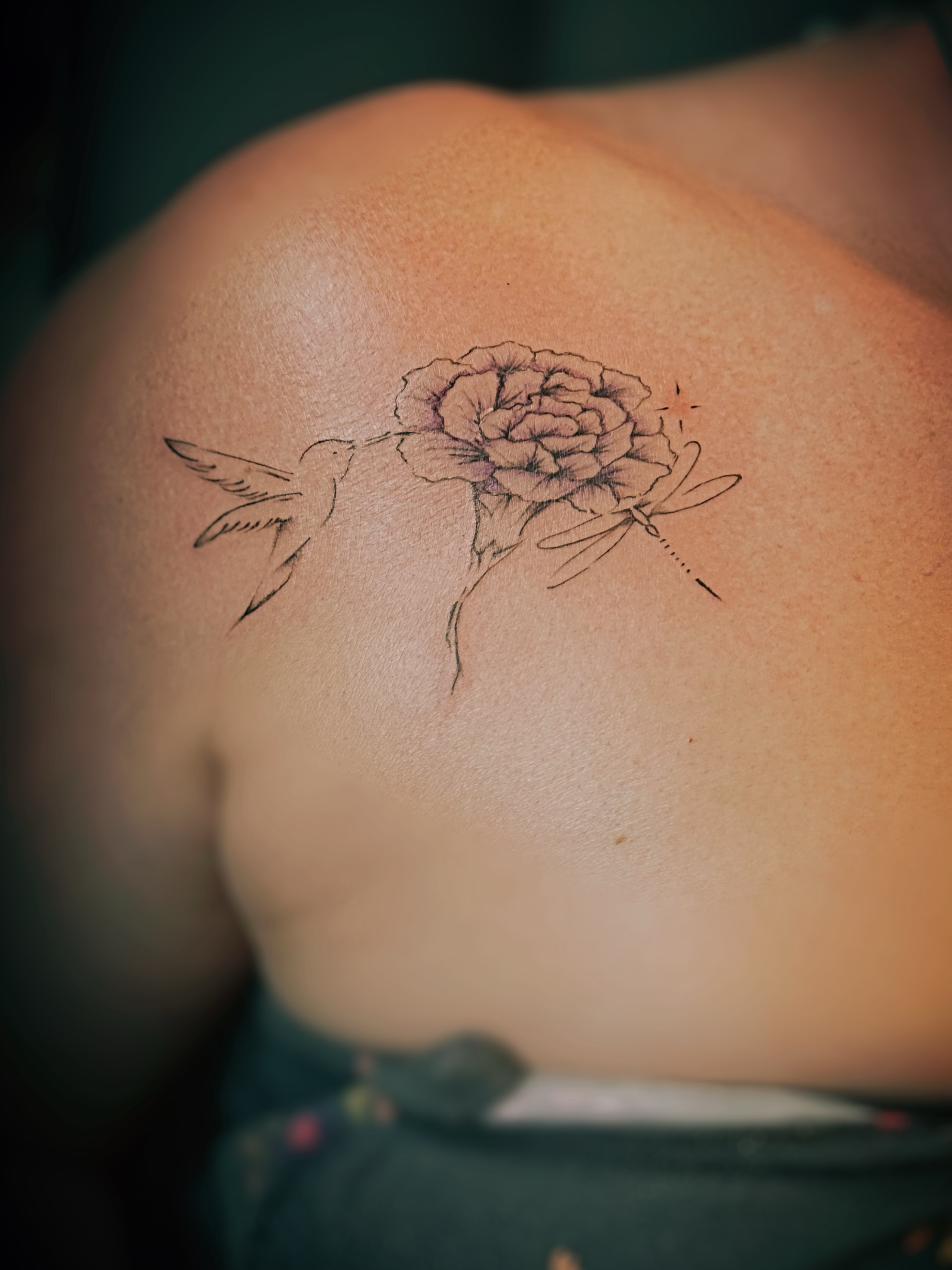Flower with hummingbird and dragonfly black and grey tattoo on the shoulder by Meagan, Charlotte, North Carolina