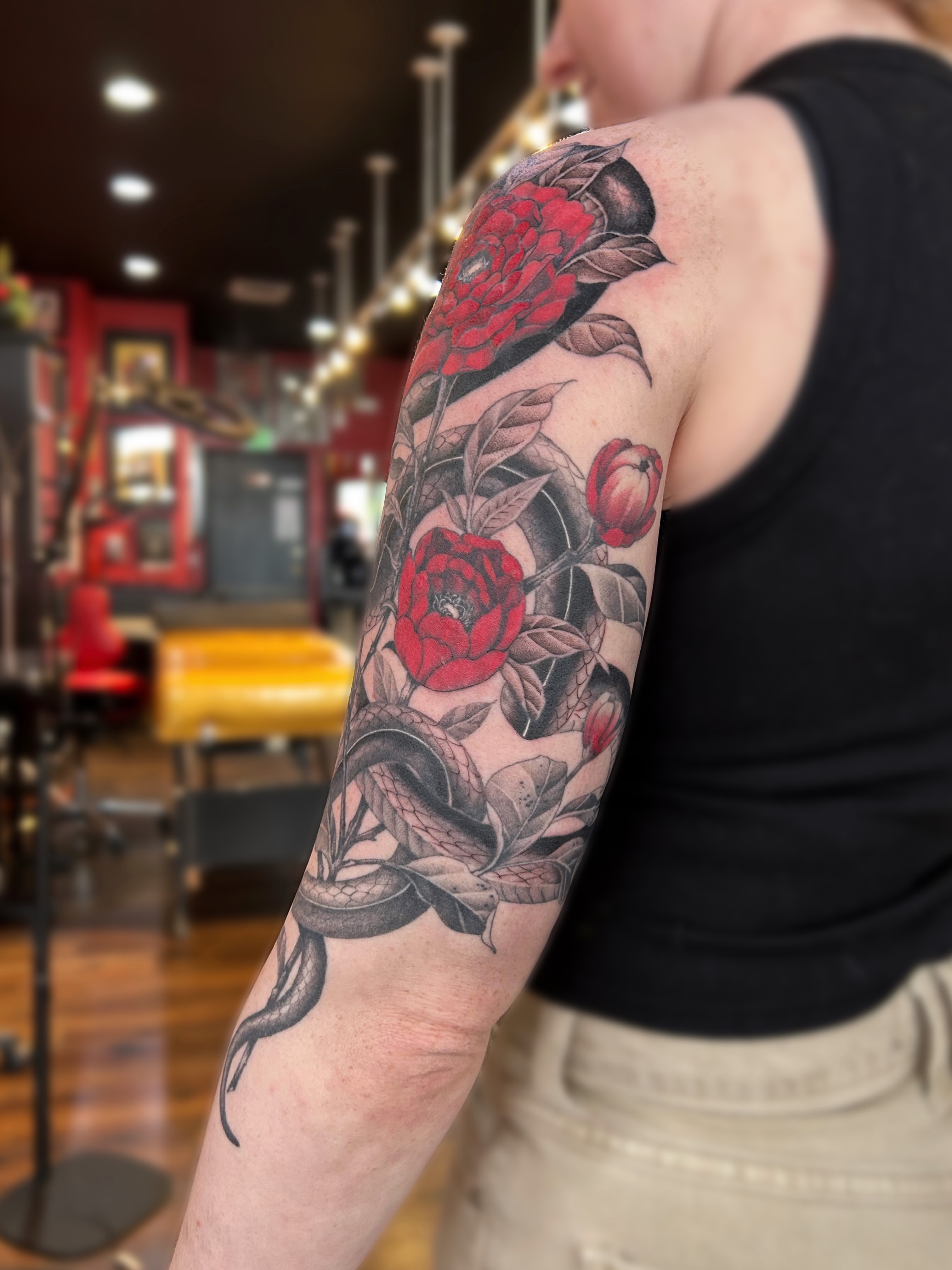 Peony and snake realism tattoo on the forearm by Tako, Seattle, Washington