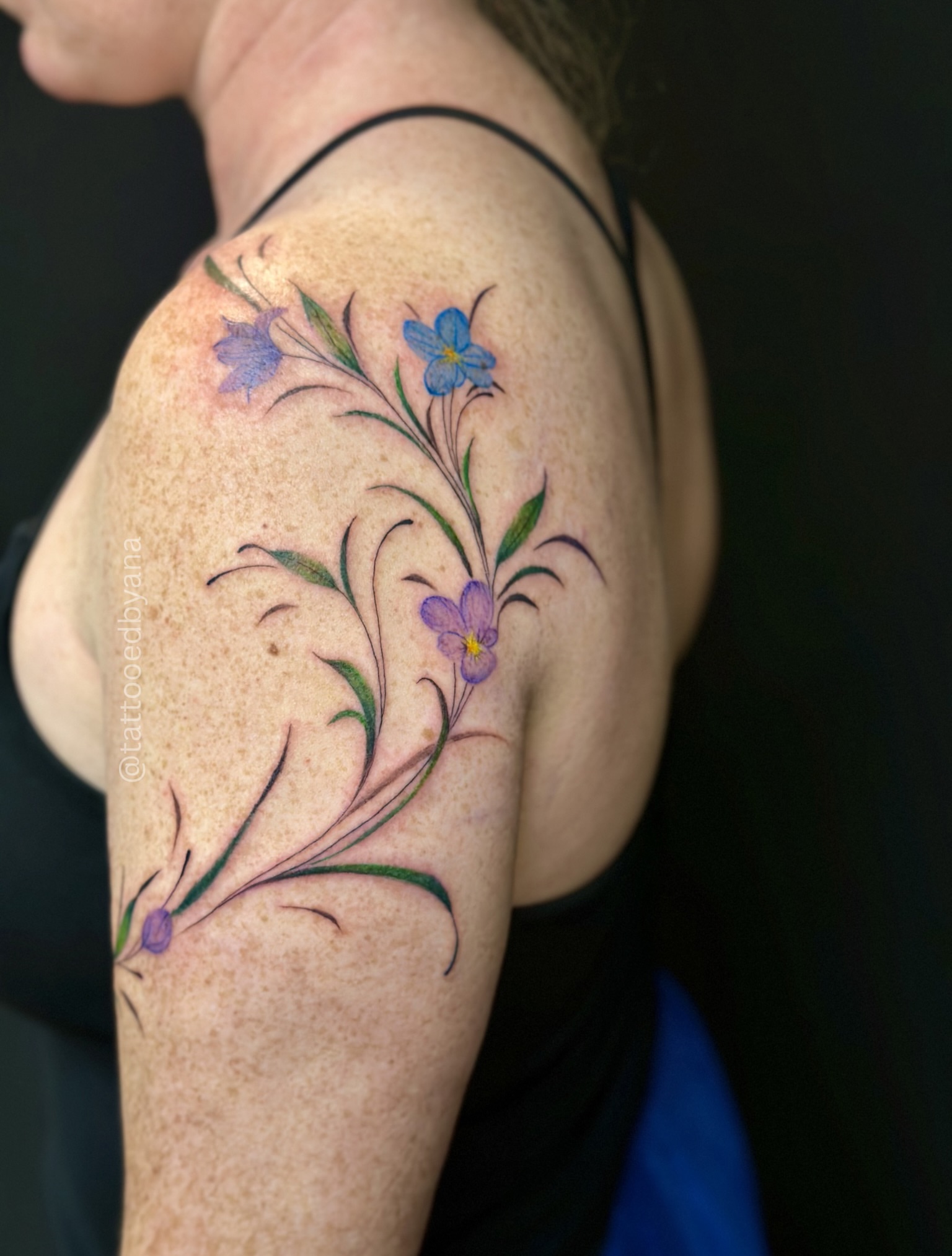 Floral design fine line tattoo on the shoulder by Tattoo artist Denver