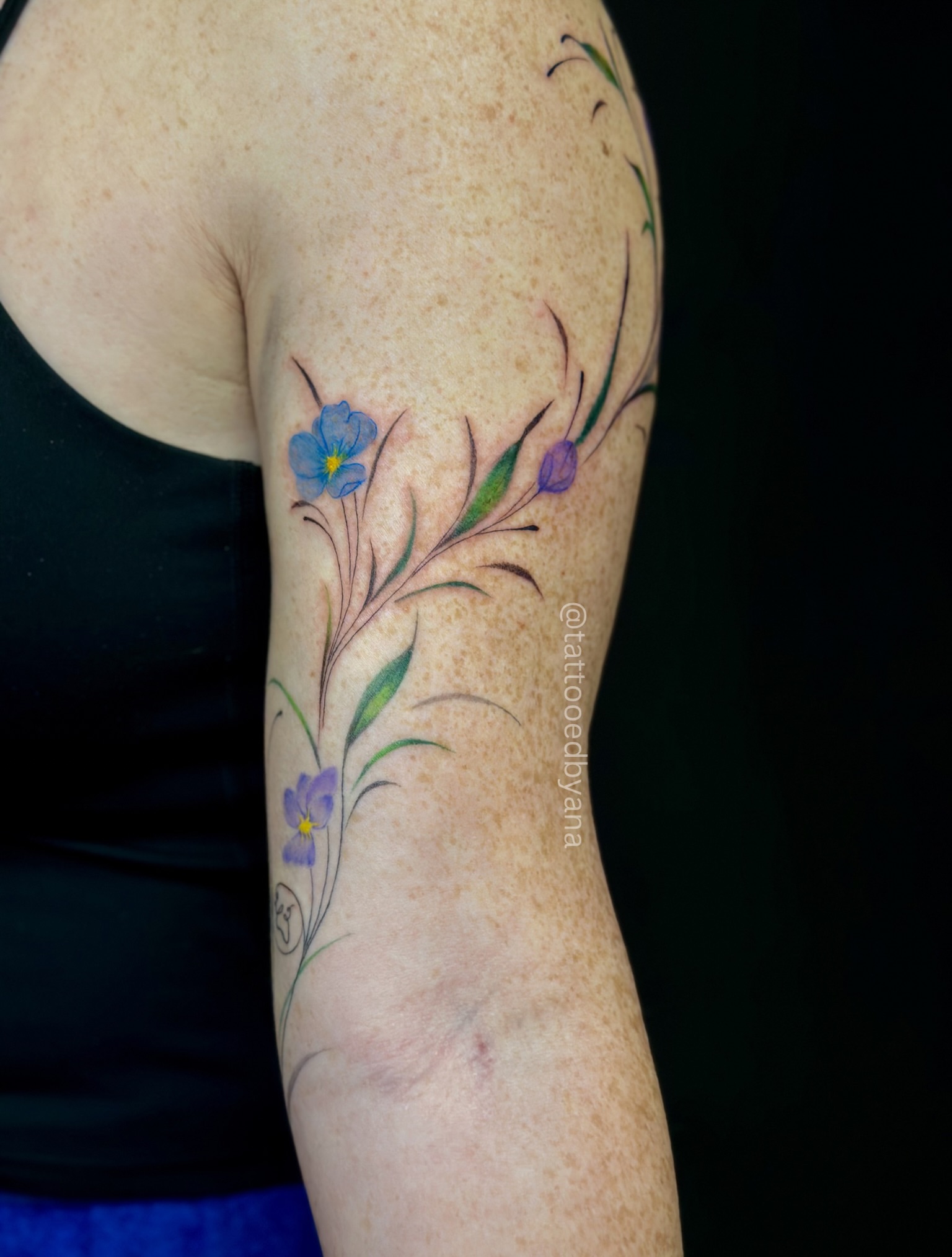 Floral design watercolor tattoo on the forearm by Tattoo artist Denver