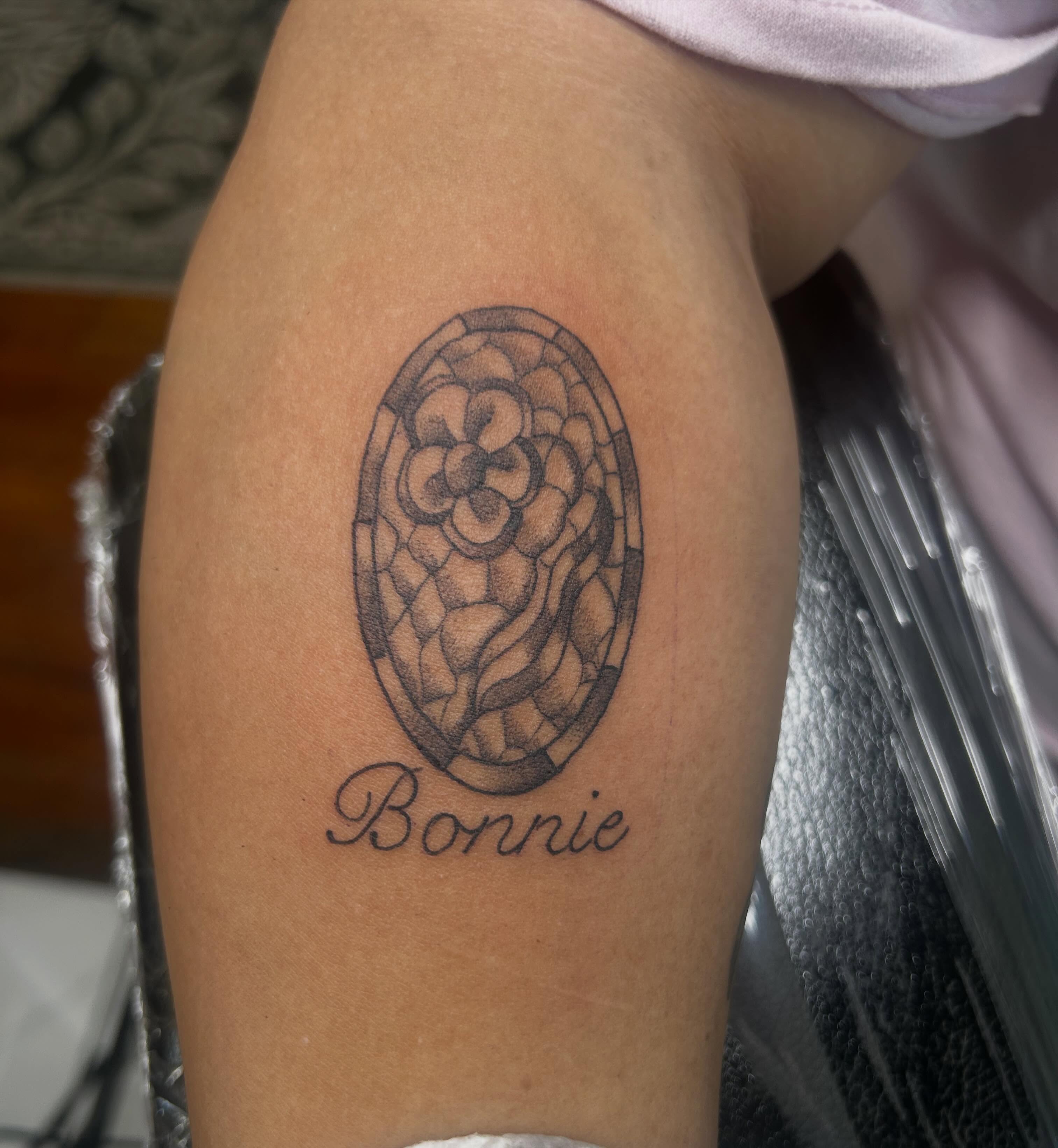 Stained glass window black and grey tattoo on the thigh by Reilley Earles
