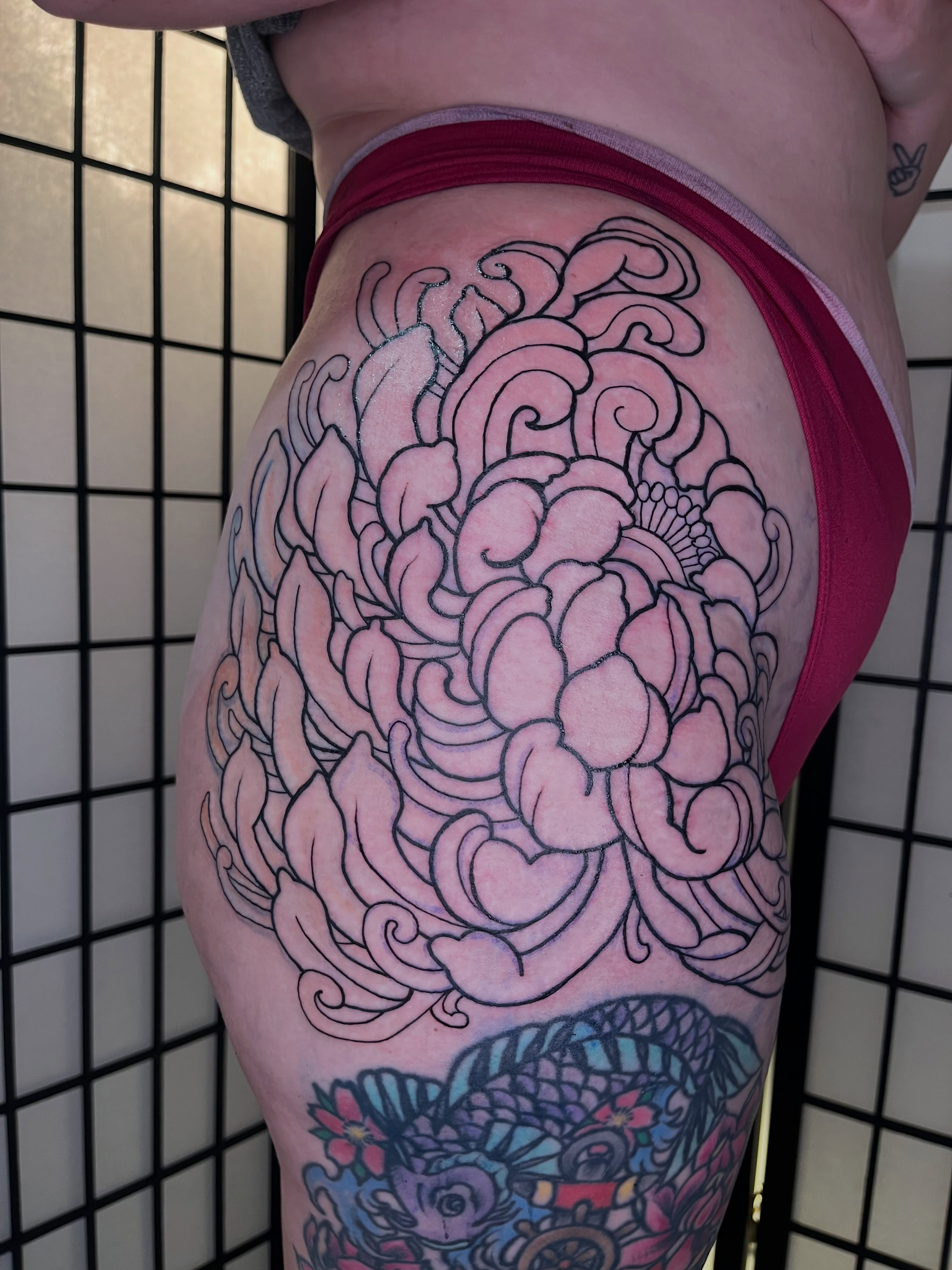 Chrysanthemum black and grey tattoo on the thigh by Lauryn Dunkle