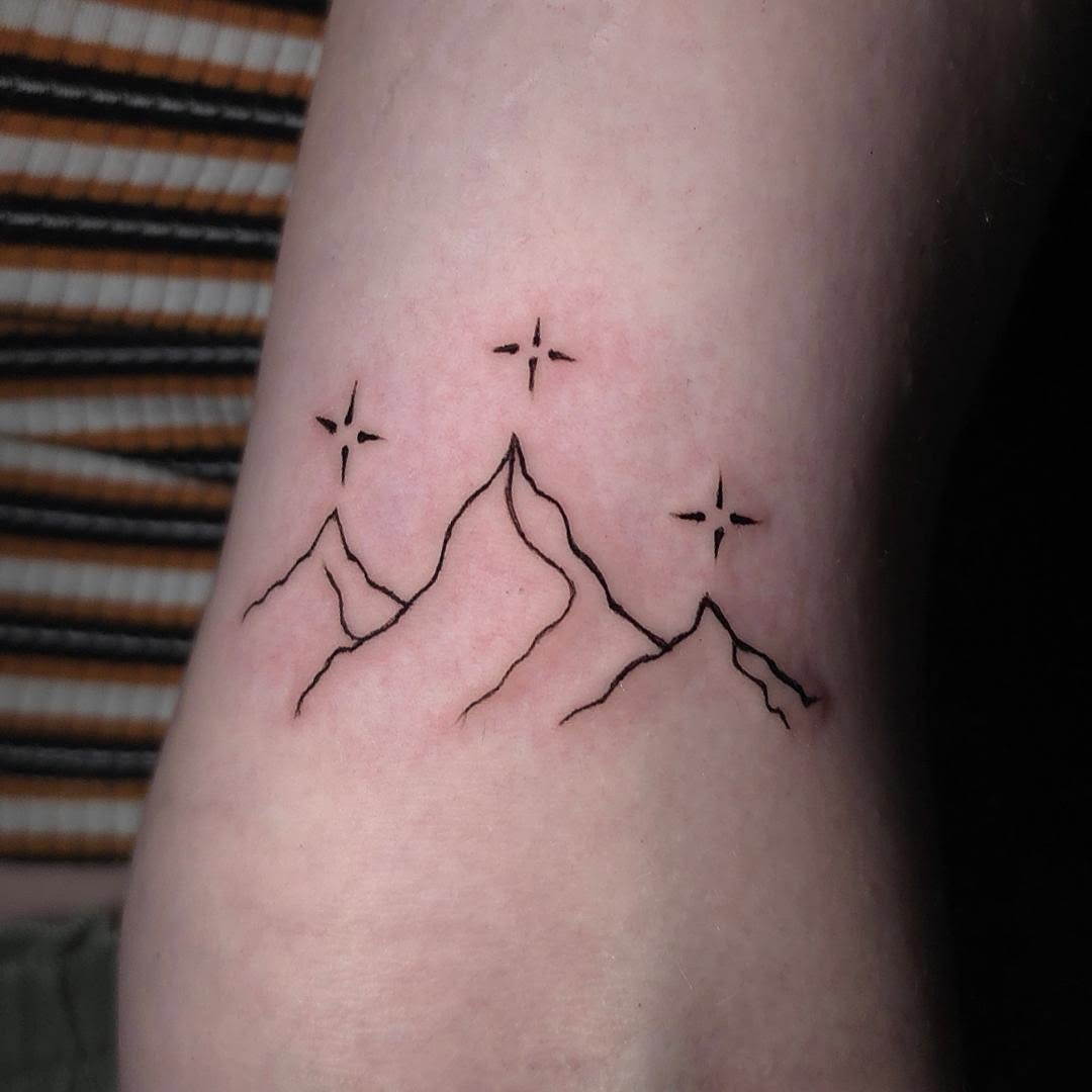 Mountains and stars minimalist tattoo on the forearm by Scar