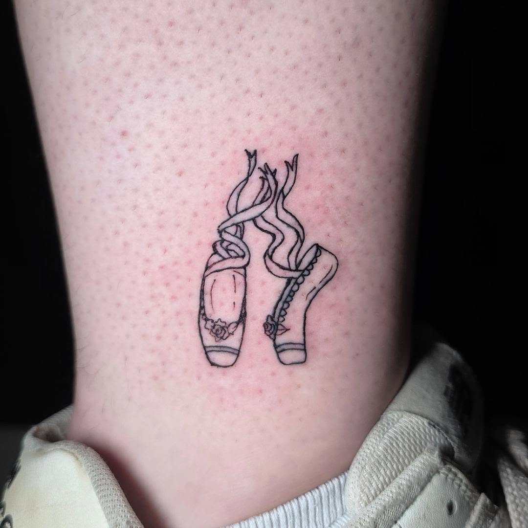 Pointe shoes black and grey tattoo on the calf by Scar