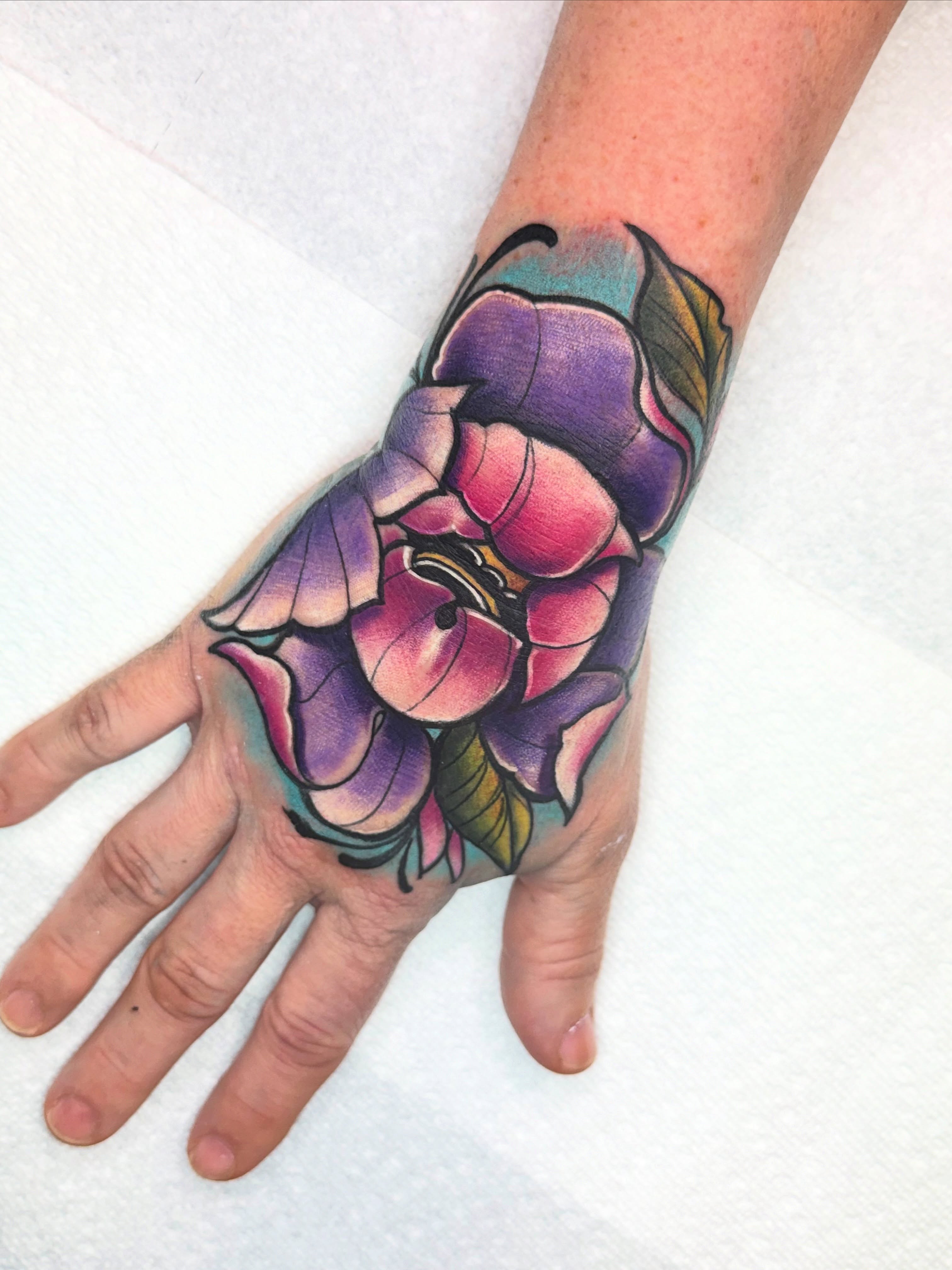 Flower American traditional tattoo on the hand by Donald Reynolds