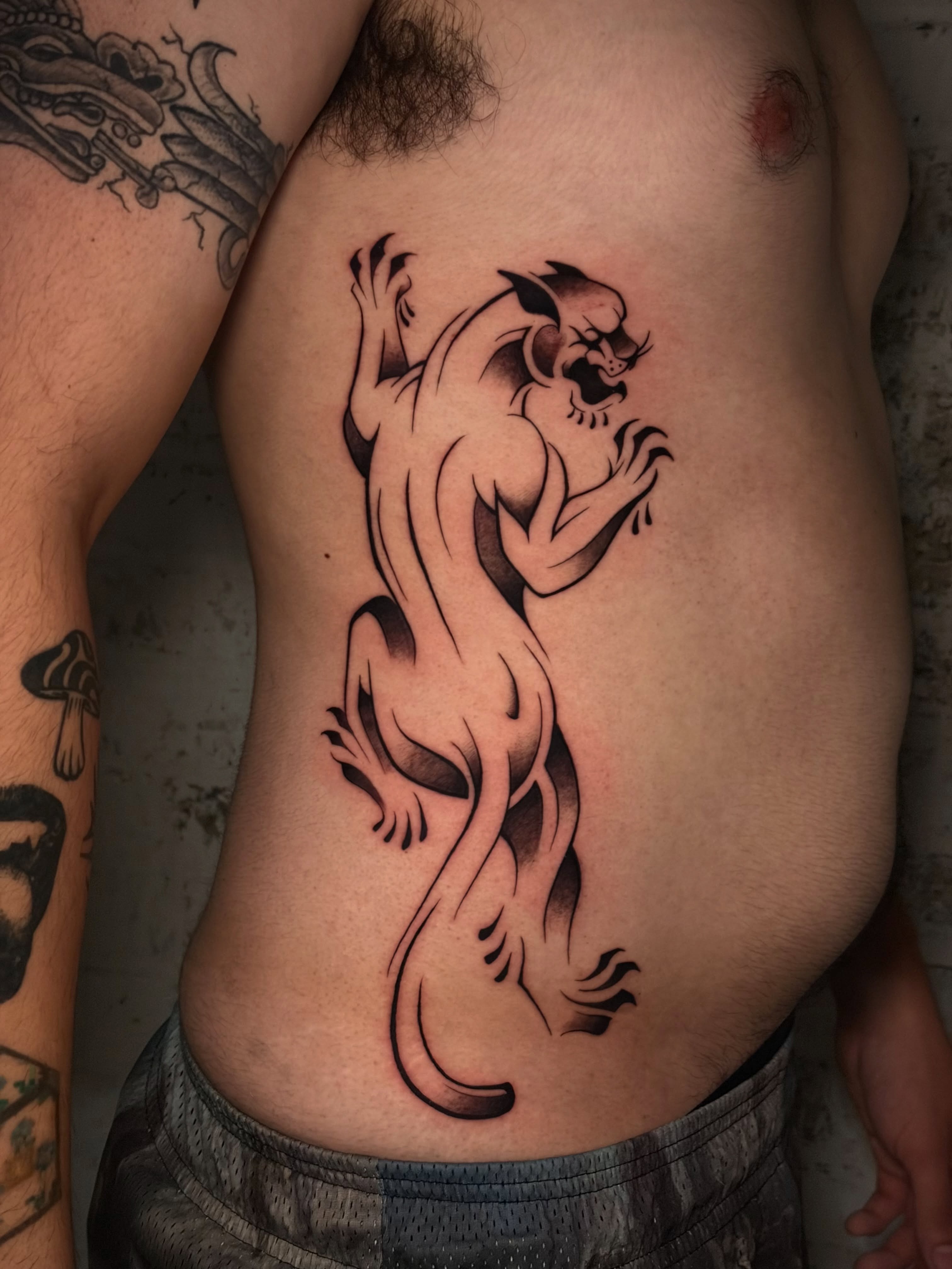 Panther black and grey tattoo on the ribs by Musa Selman