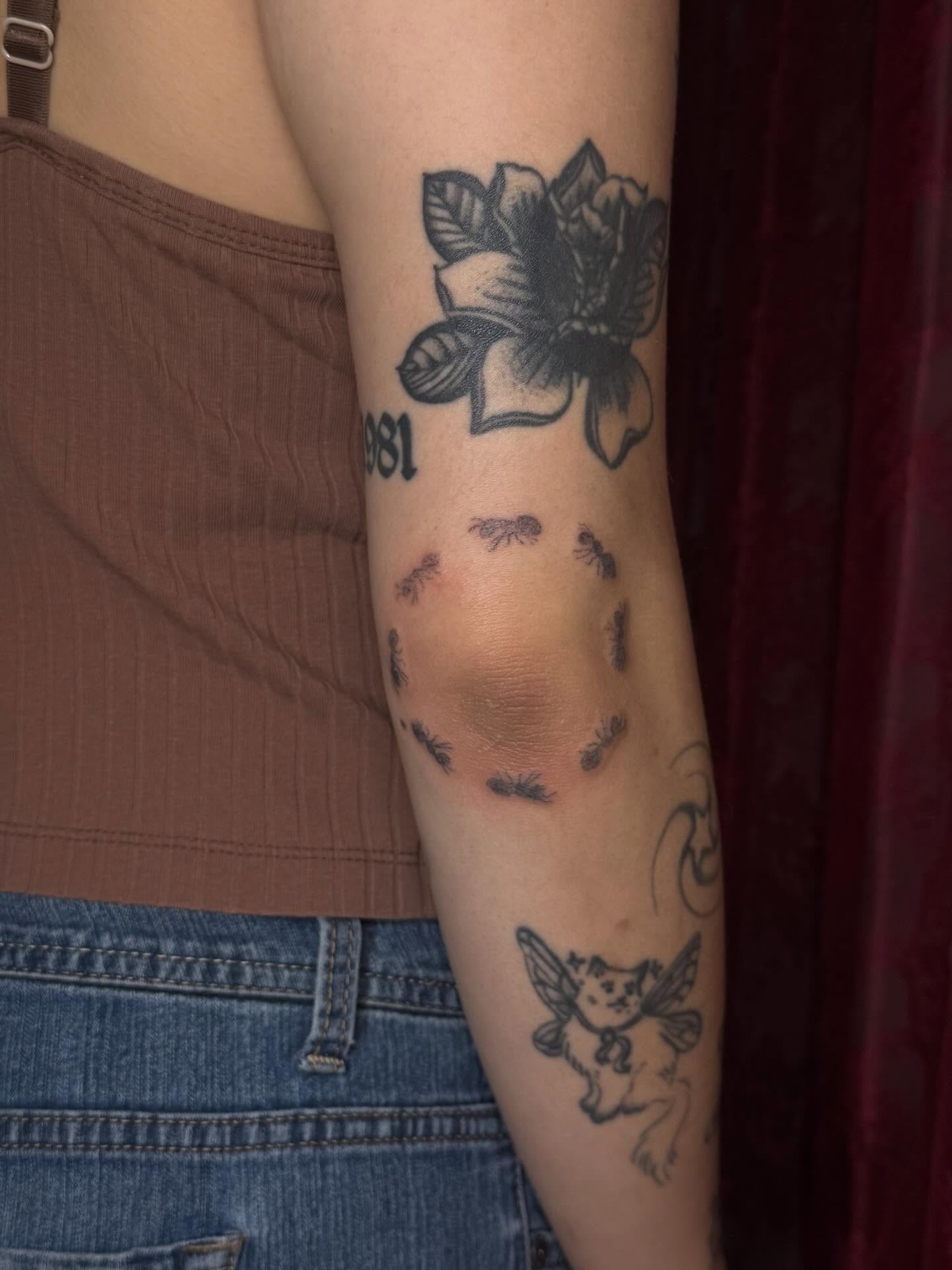 Flower with ants black and grey tattoo on the forearm by mar