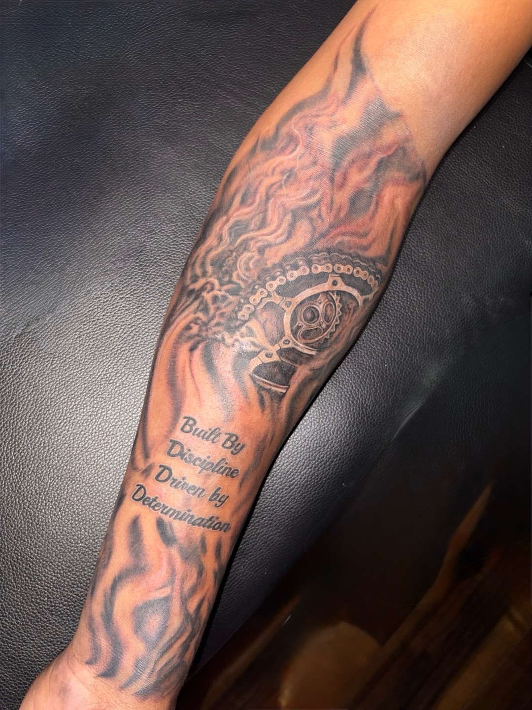 Motorcycle chain and gear realism tattoo on the forearm by K.L Tattoo Uptown