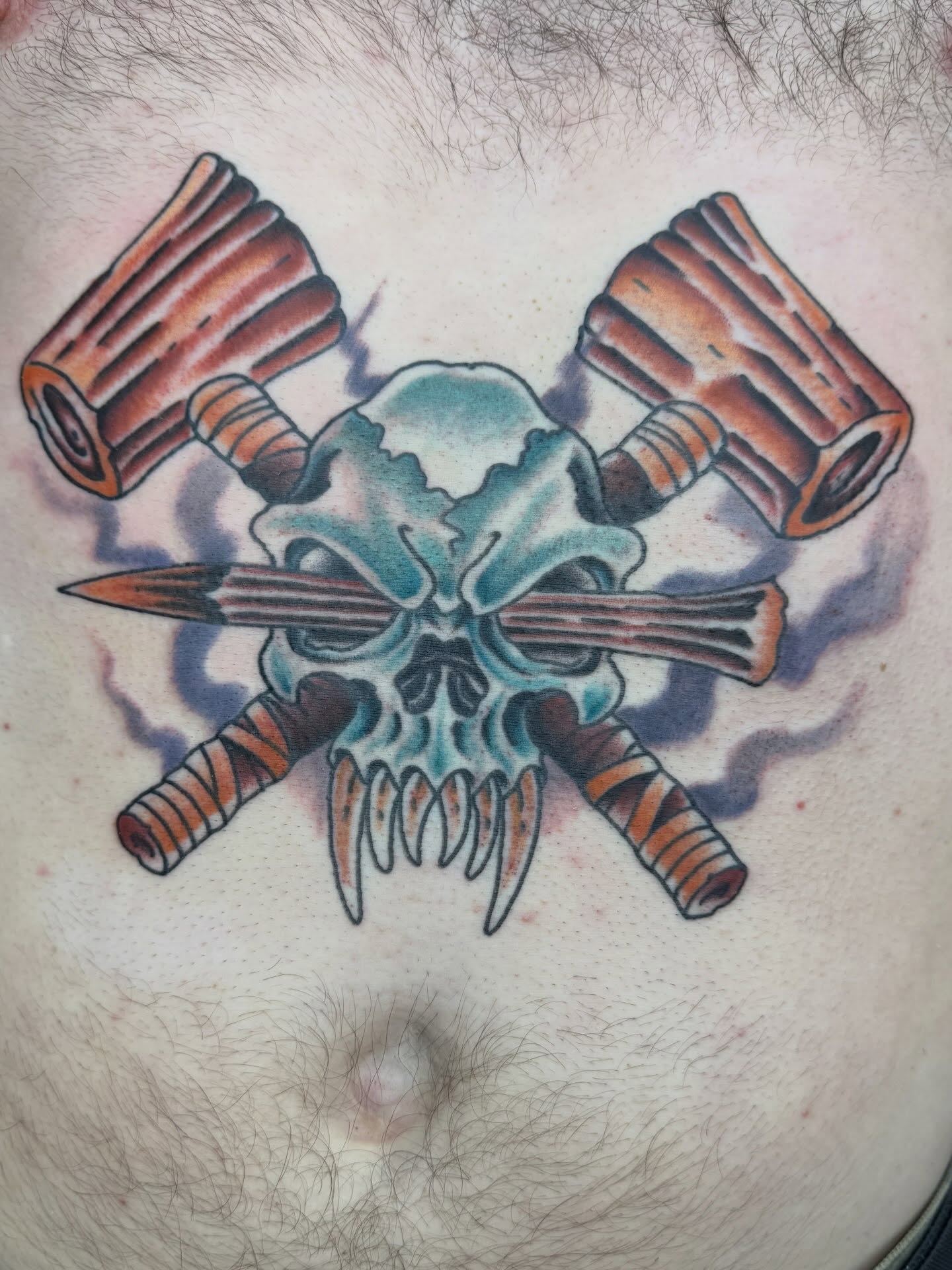 Skull with crossed bullets American traditional tattoo on the chest by Trent Parsley