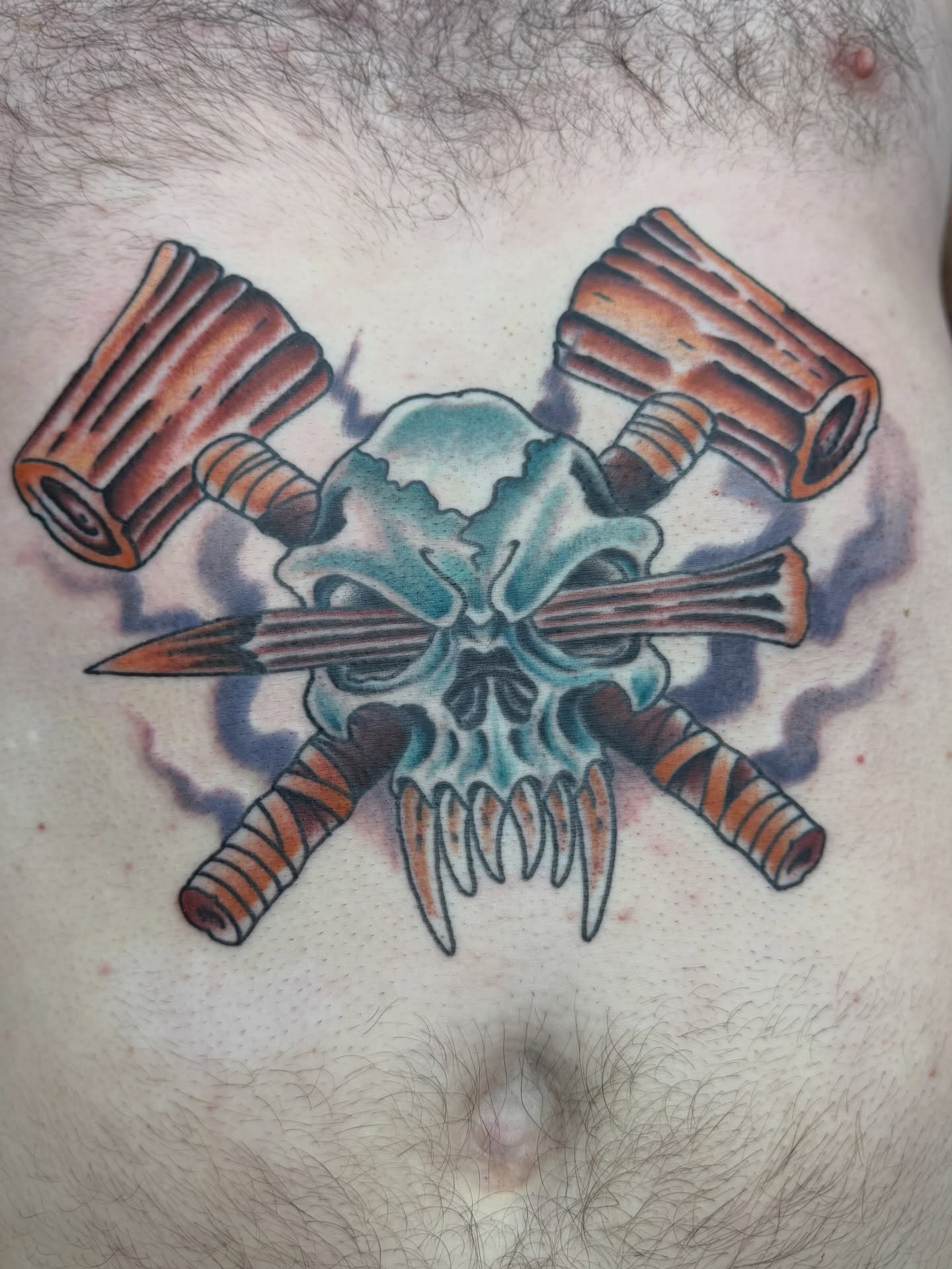 Skull with crossed dumdums American traditional tattoo on the chest by Trent Parsley