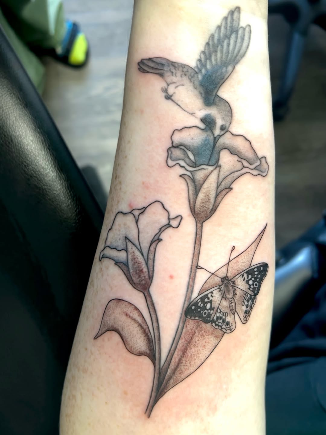 Hummingbird and flowers with butterfly fine line tattoo on the forearm by Cortnie, Nashville, Tennessee