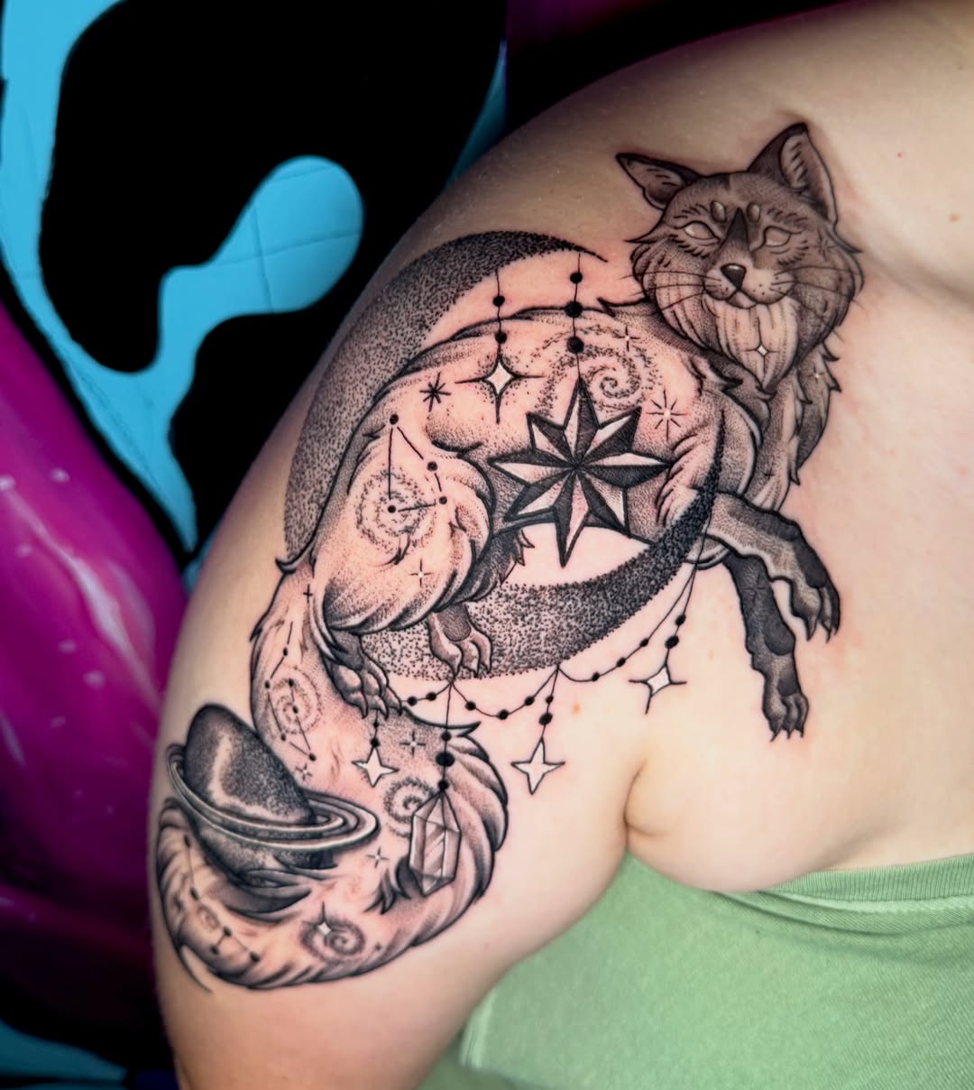 Cat and celestial symbols dotwork tattoo on the shoulder by Rebecca Preble